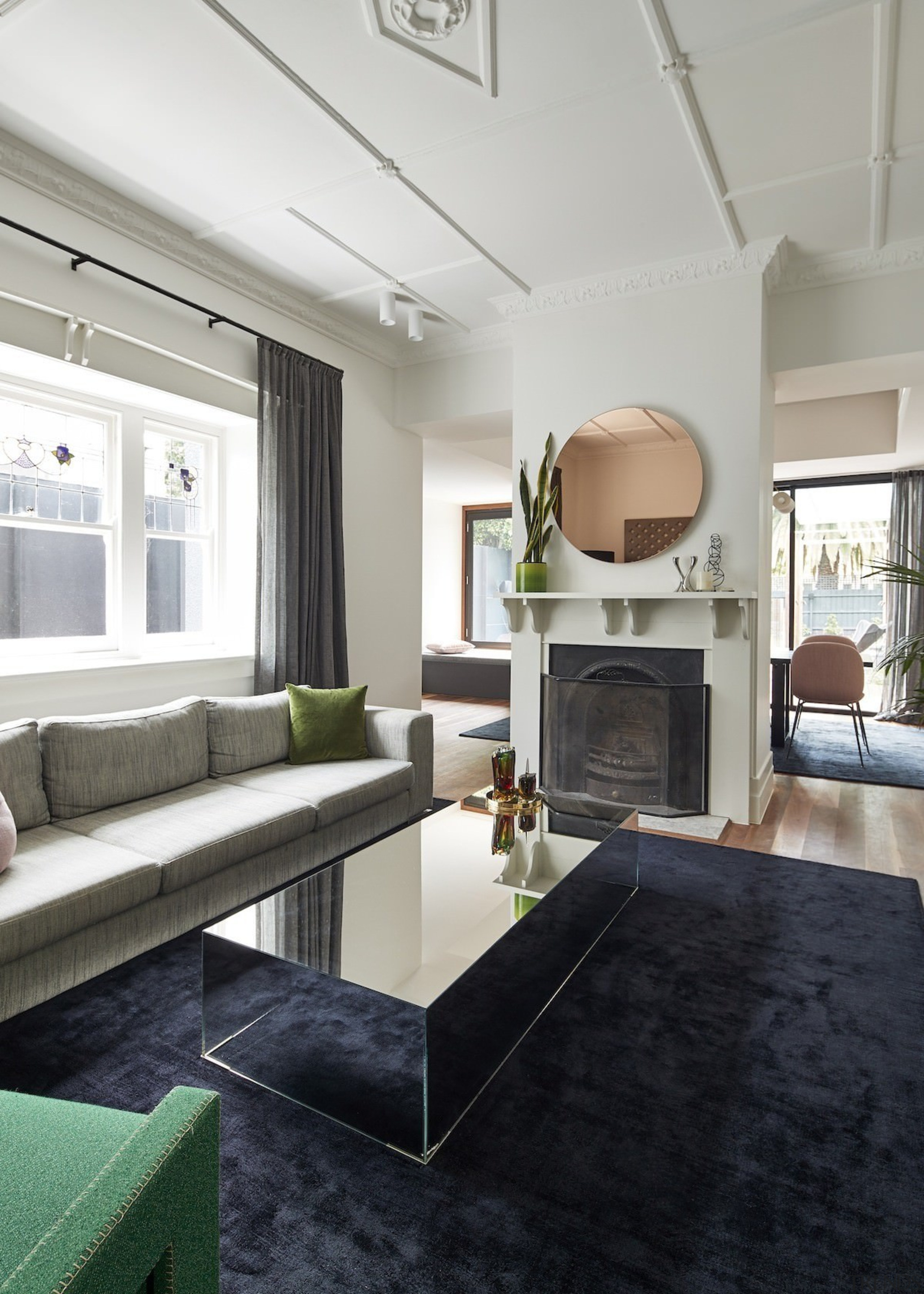 The renovation respects the original home, with ceiling ceiling, floor, interior design, living room, room, table, gray, black