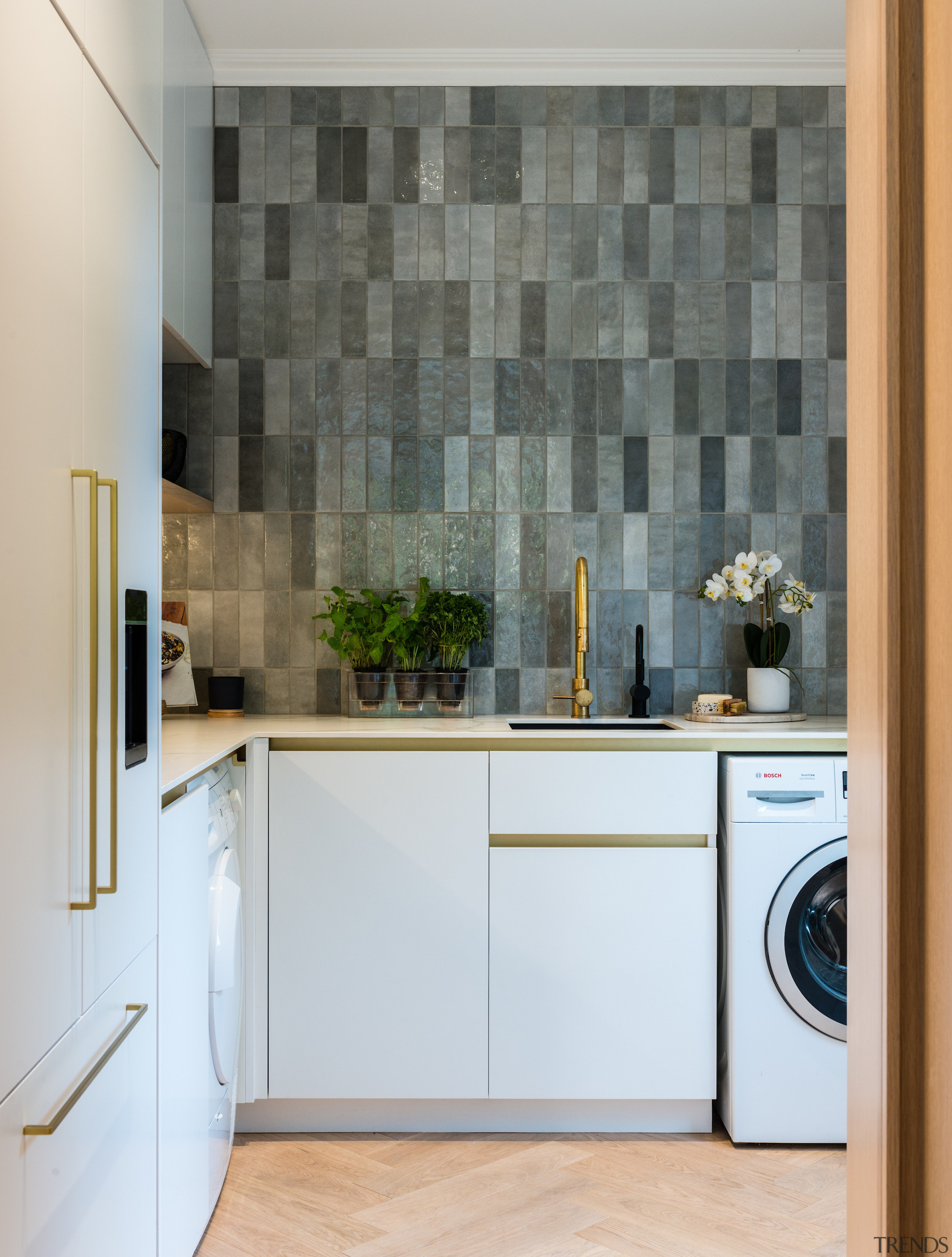 Brass tapware pings against the refined tile splashback 