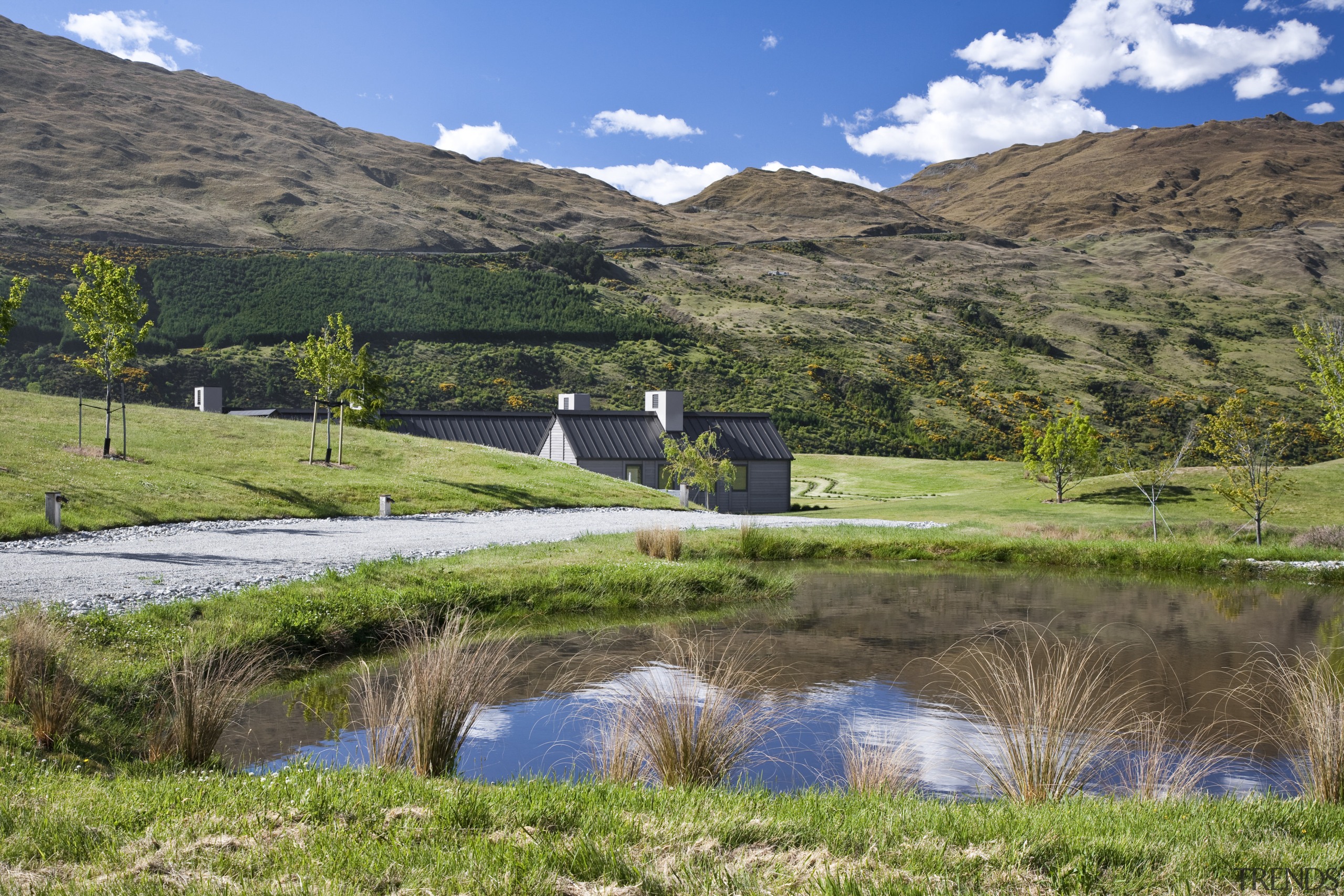 Exterior view of a country home which features farm, fell, field, grass, grass family, grassland, highland, hill, lake, landscape, loch, meadow, mountain, nature reserve, pasture, plant, reflection, reservoir, rural area, sky, tarn, tree, water, water resources, wilderness, brown