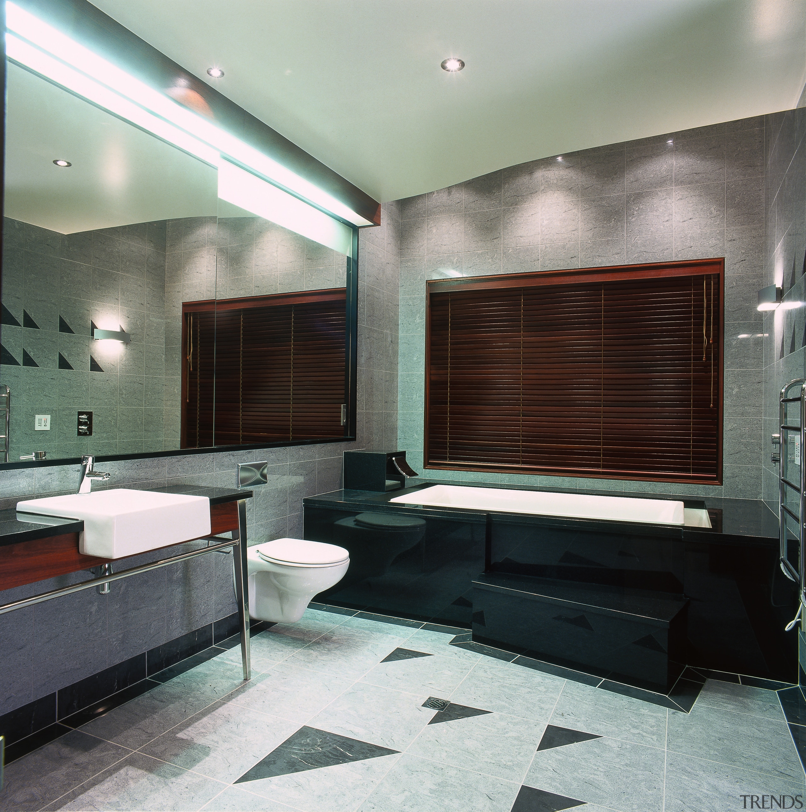 view of the bathroom featuring free standing vanity, bathroom, ceiling, floor, flooring, interior design, room, tile, gray, black