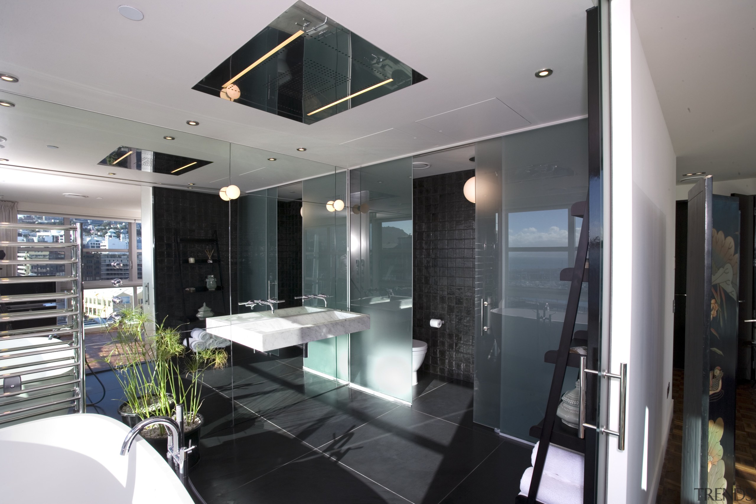 The bathroom features a fully mirrored wall, rain glass, interior design, window, gray, black