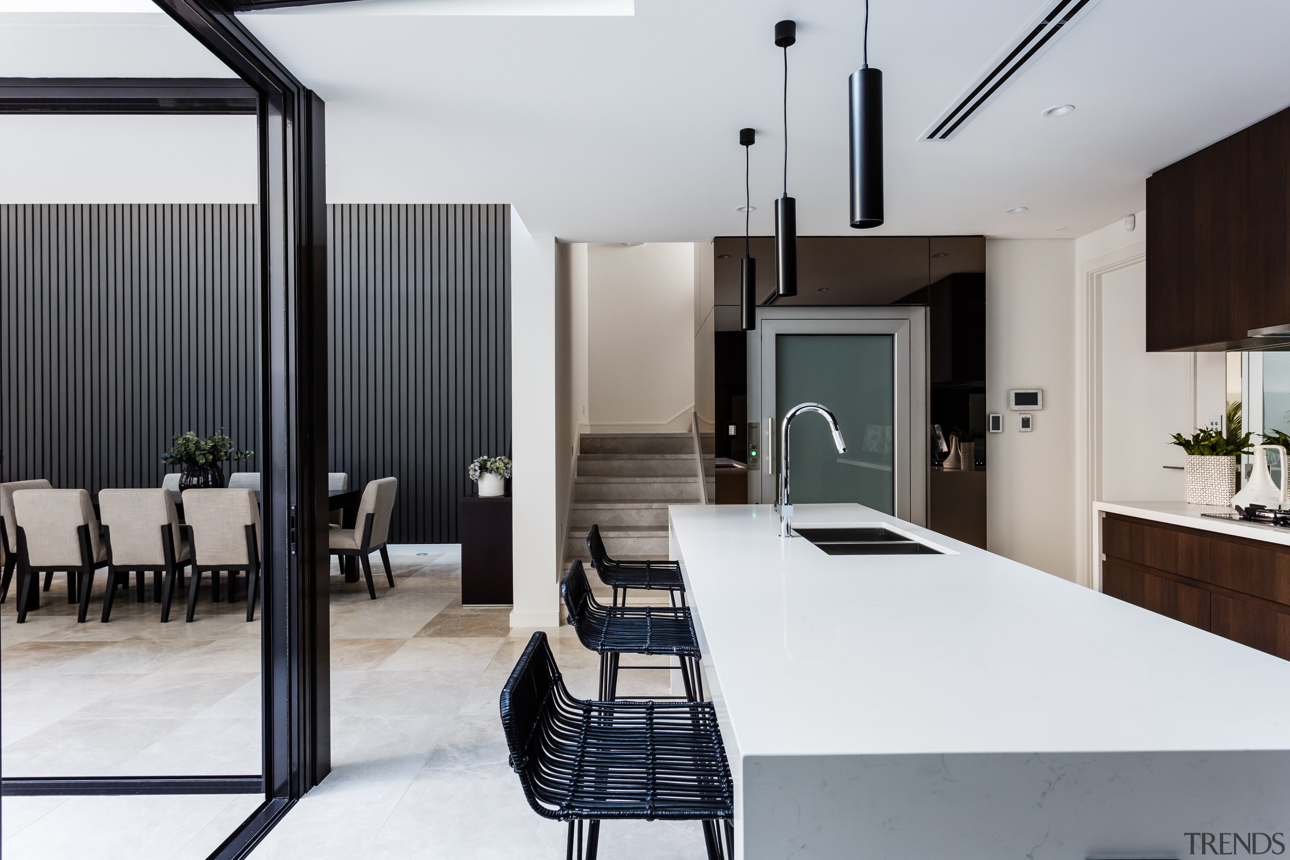 This two-tone kitchen is on view from the architecture, house, interior design, table, white, gray, black