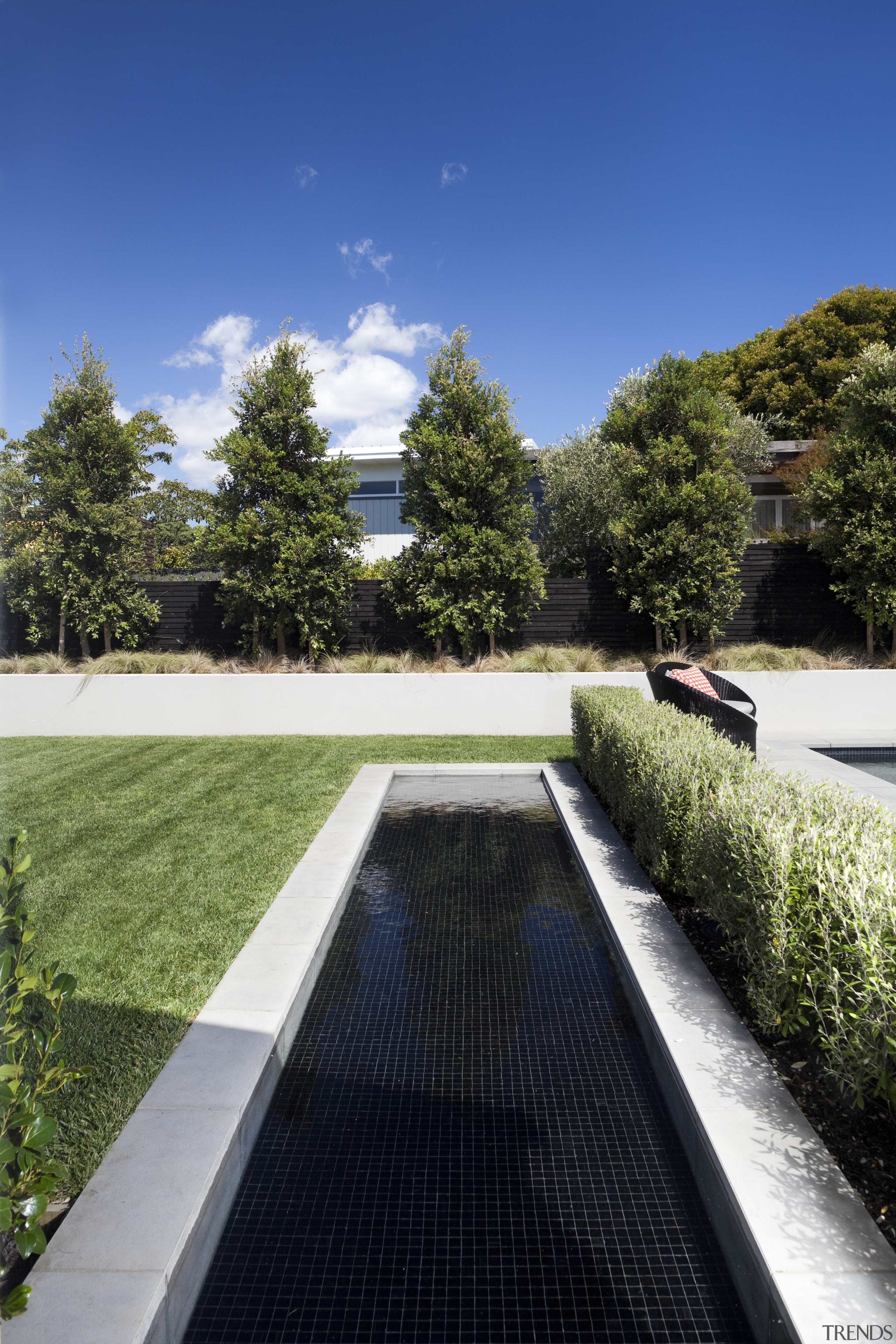 Here is a home designed by Belinda George architecture, daytime, estate, garden, grass, home, house, landscape, lawn, plant, real estate, reflecting pool, reflection, residential area, roof, sky, tree, walkway, water, blue