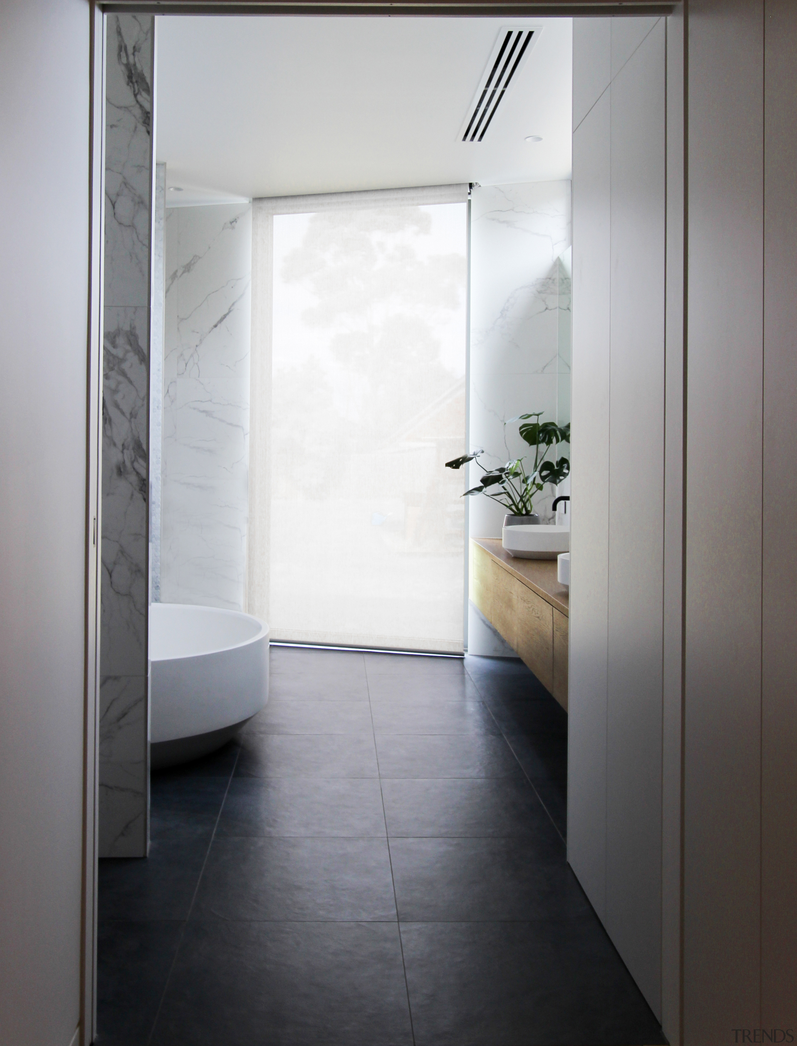 A large inoperable window in this master ensuite gray