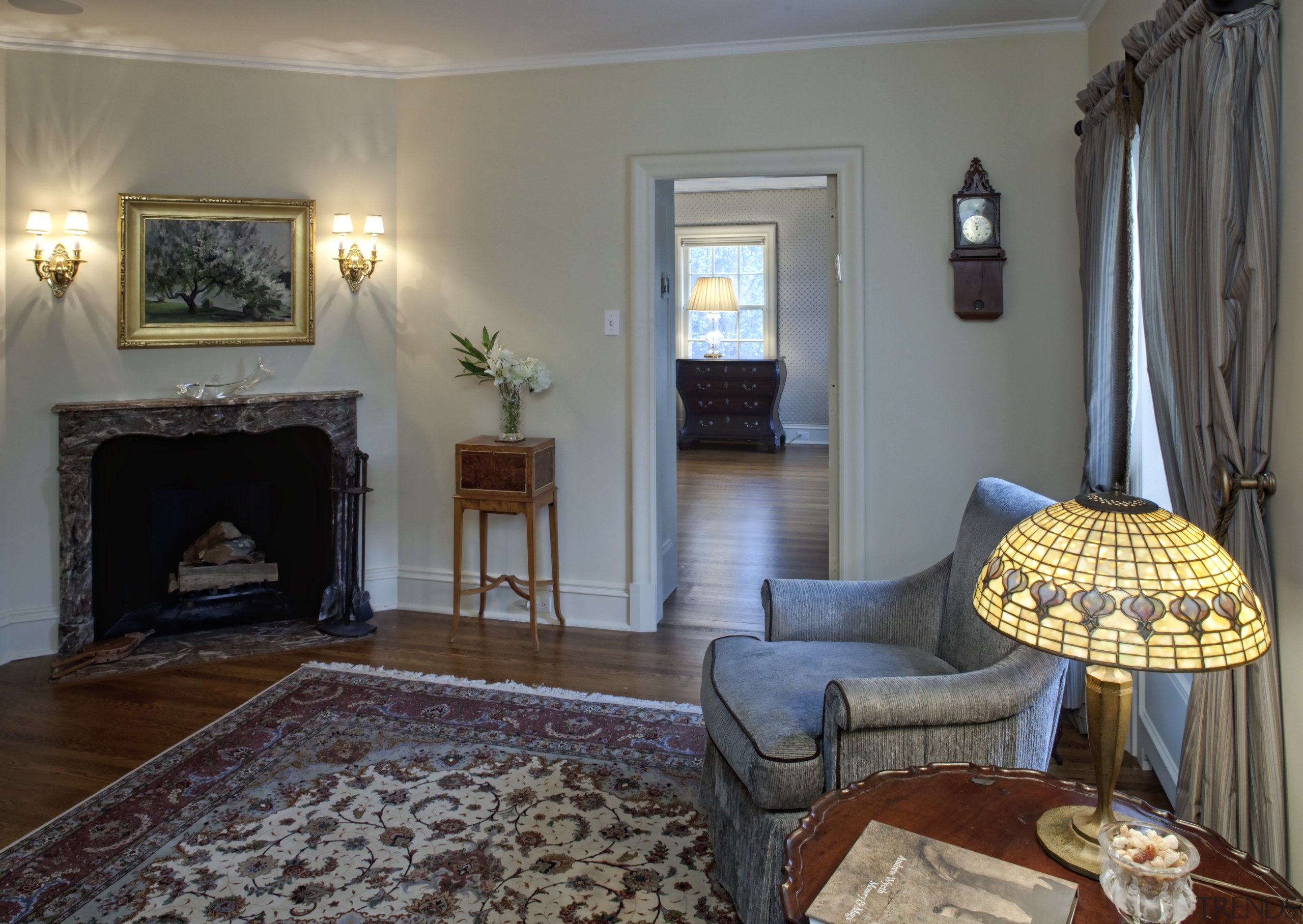 View of the sitting room featuring traditional-styled seating, ceiling, estate, fireplace, floor, flooring, hardwood, hearth, home, house, interior design, living room, property, real estate, room, wall, window treatment, gray