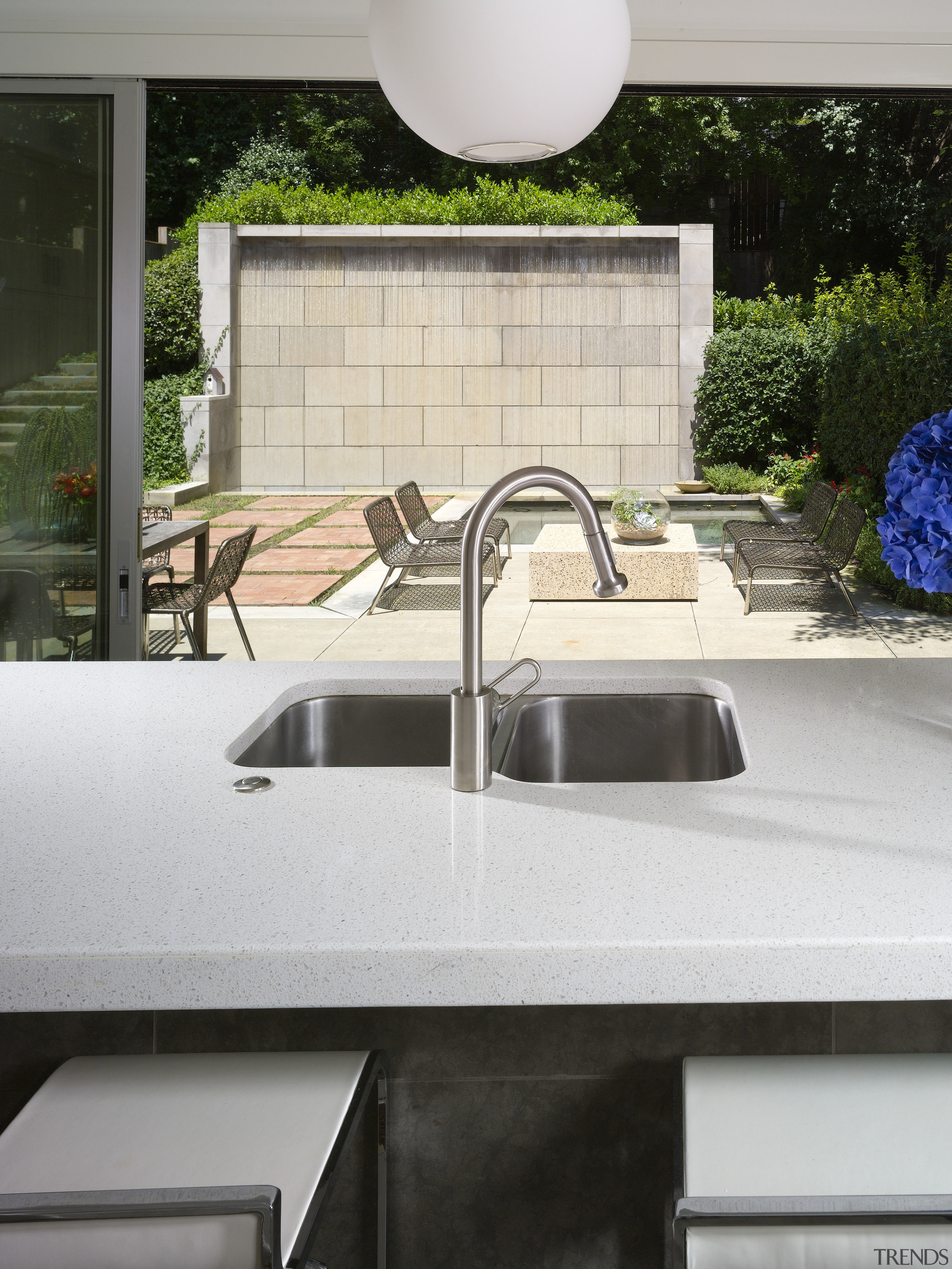 View of kitchen featuring island with CaesarStone countertops, architecture, countertop, sink, tap, white