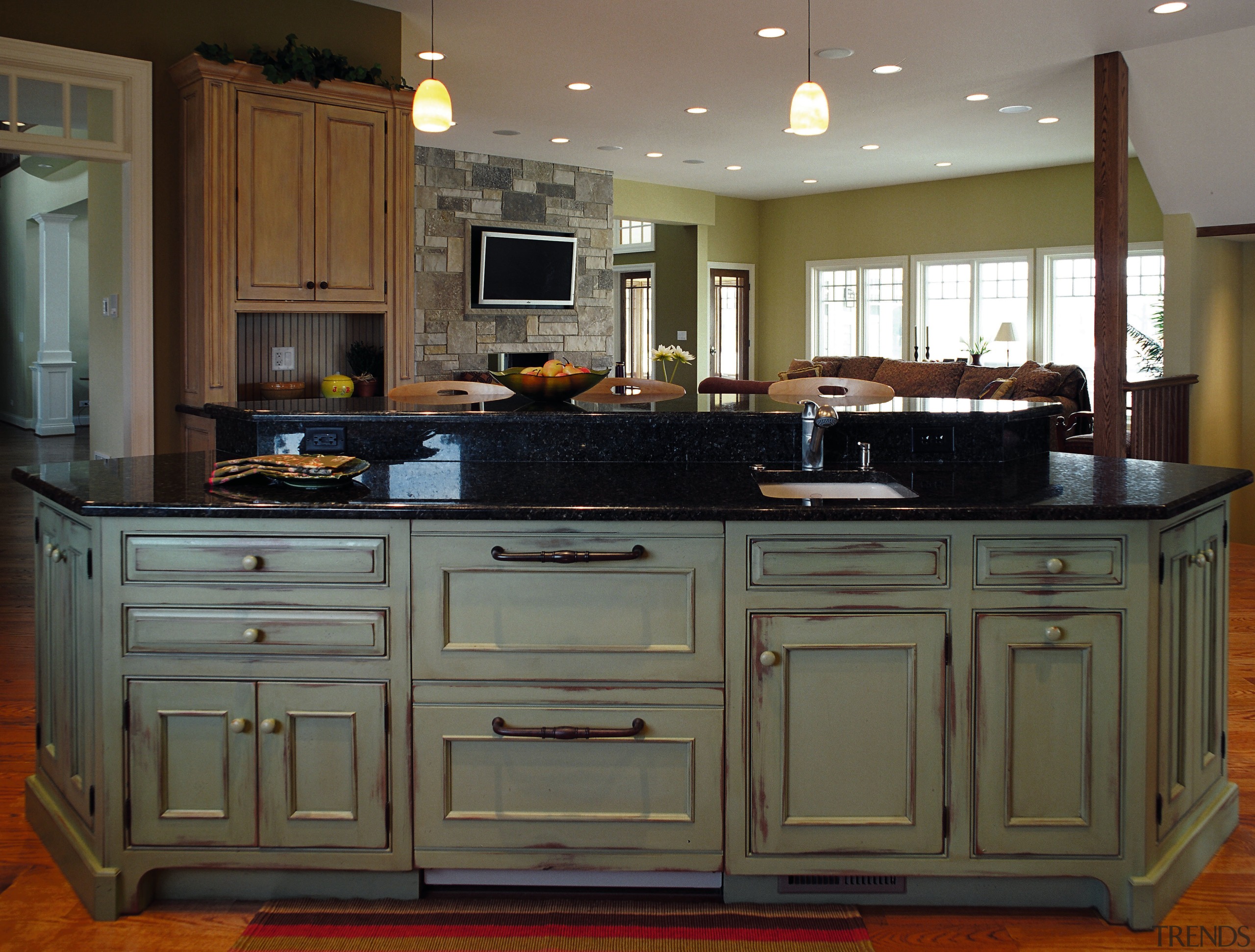 View of this traditional kitchen featuring grean teak cabinetry, countertop, cuisine classique, furniture, hardwood, kitchen, room, gray, brown, black