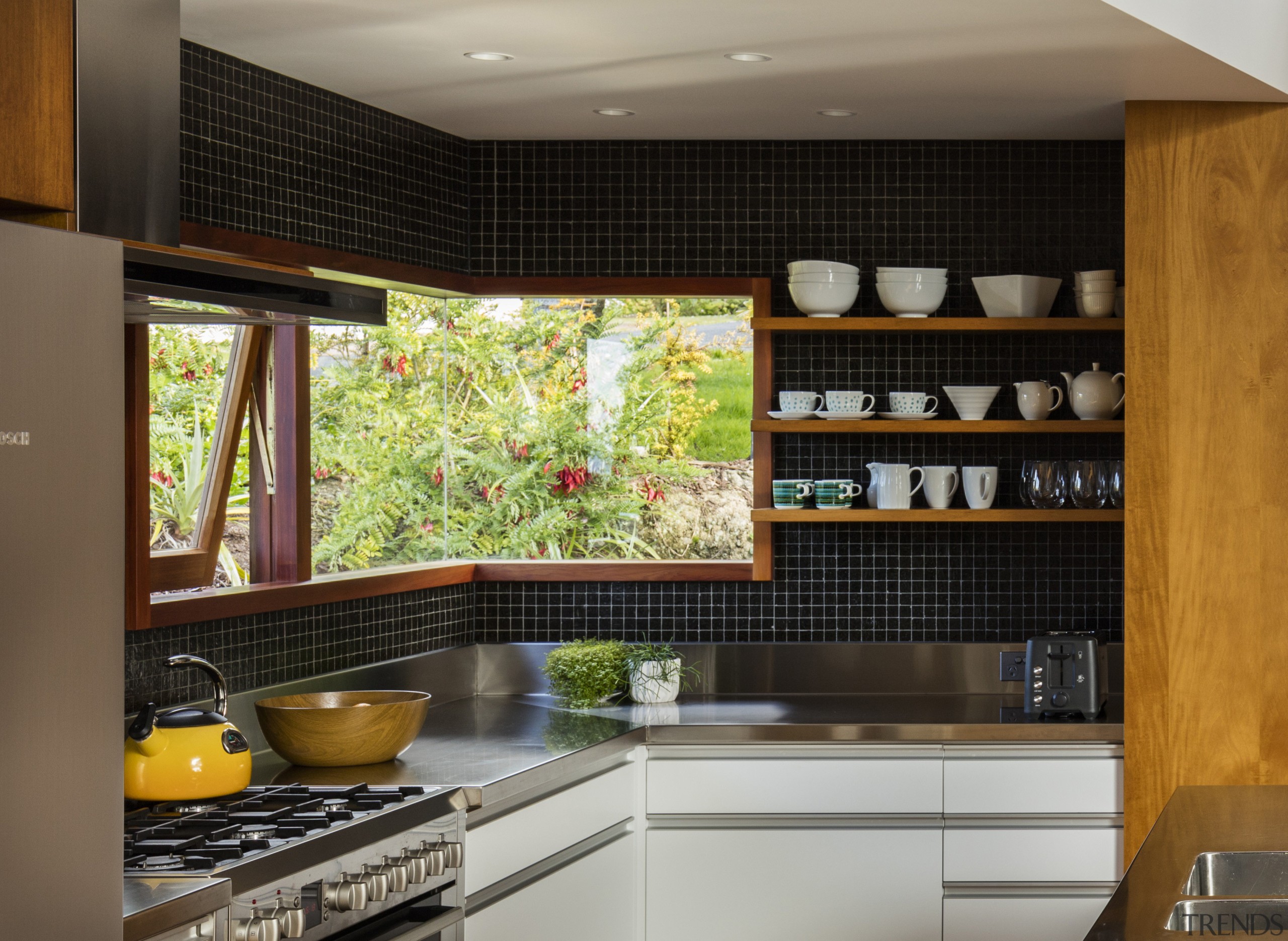 A frameless corner window helps this kitchen niche cabinetry, countertop, interior design, kitchen, under cabinet lighting, black