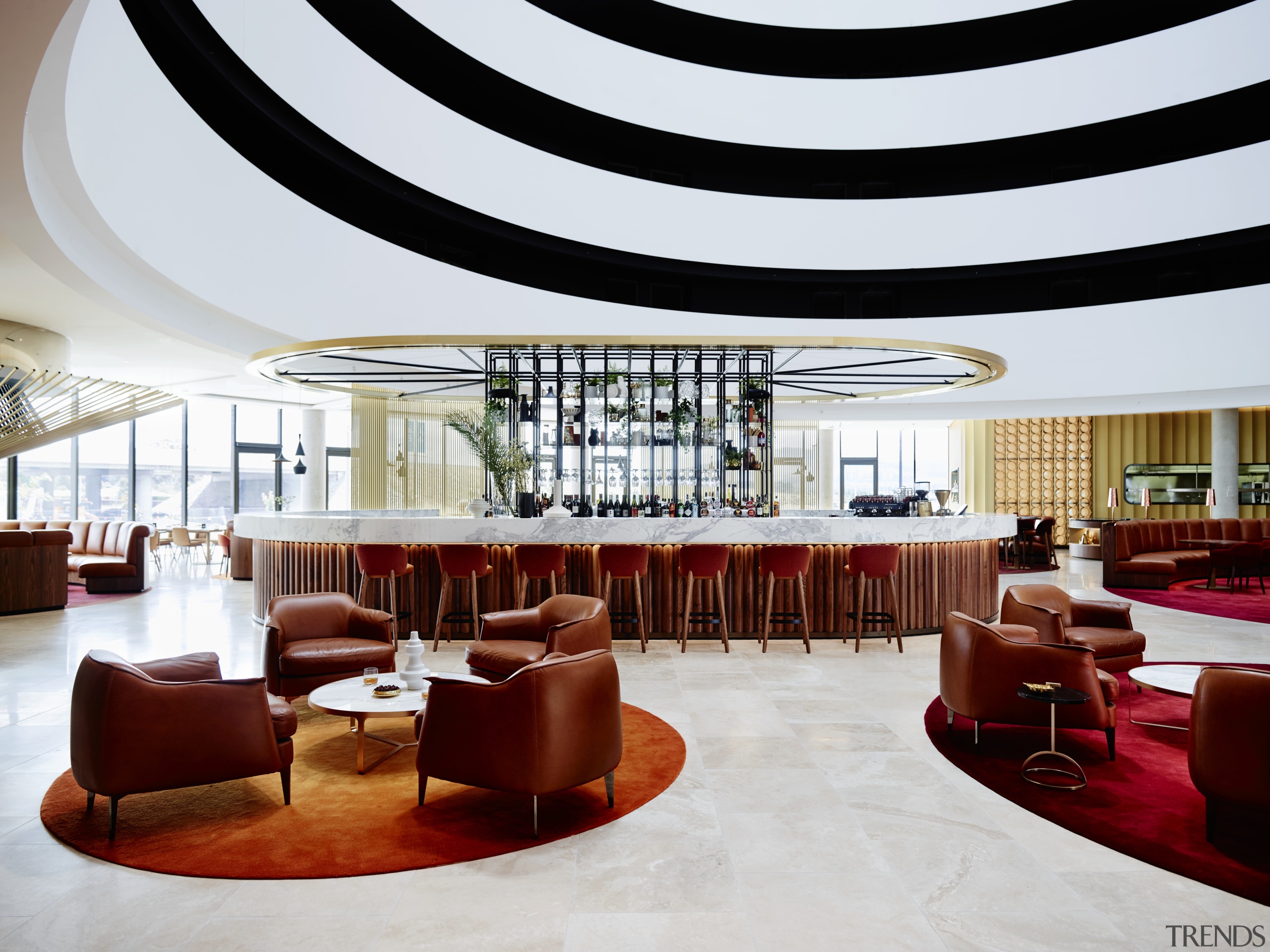 A curvaceous bar area provides the social focal ceiling, function hall, interior design, lobby, restaurant, table, white