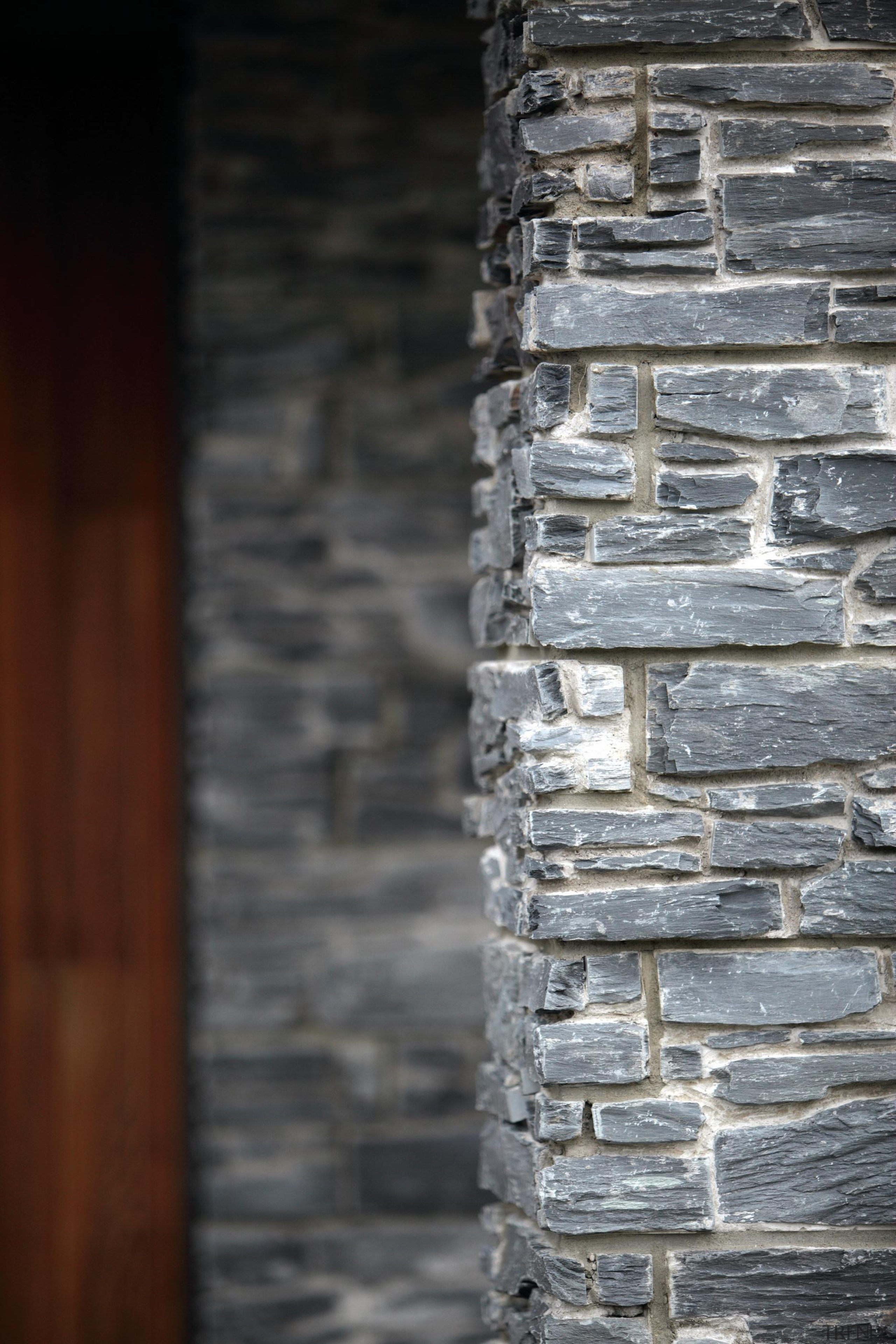 The Designa Schist column system makes it so brick, stone wall, structure, texture, wall, window, wood, gray, black