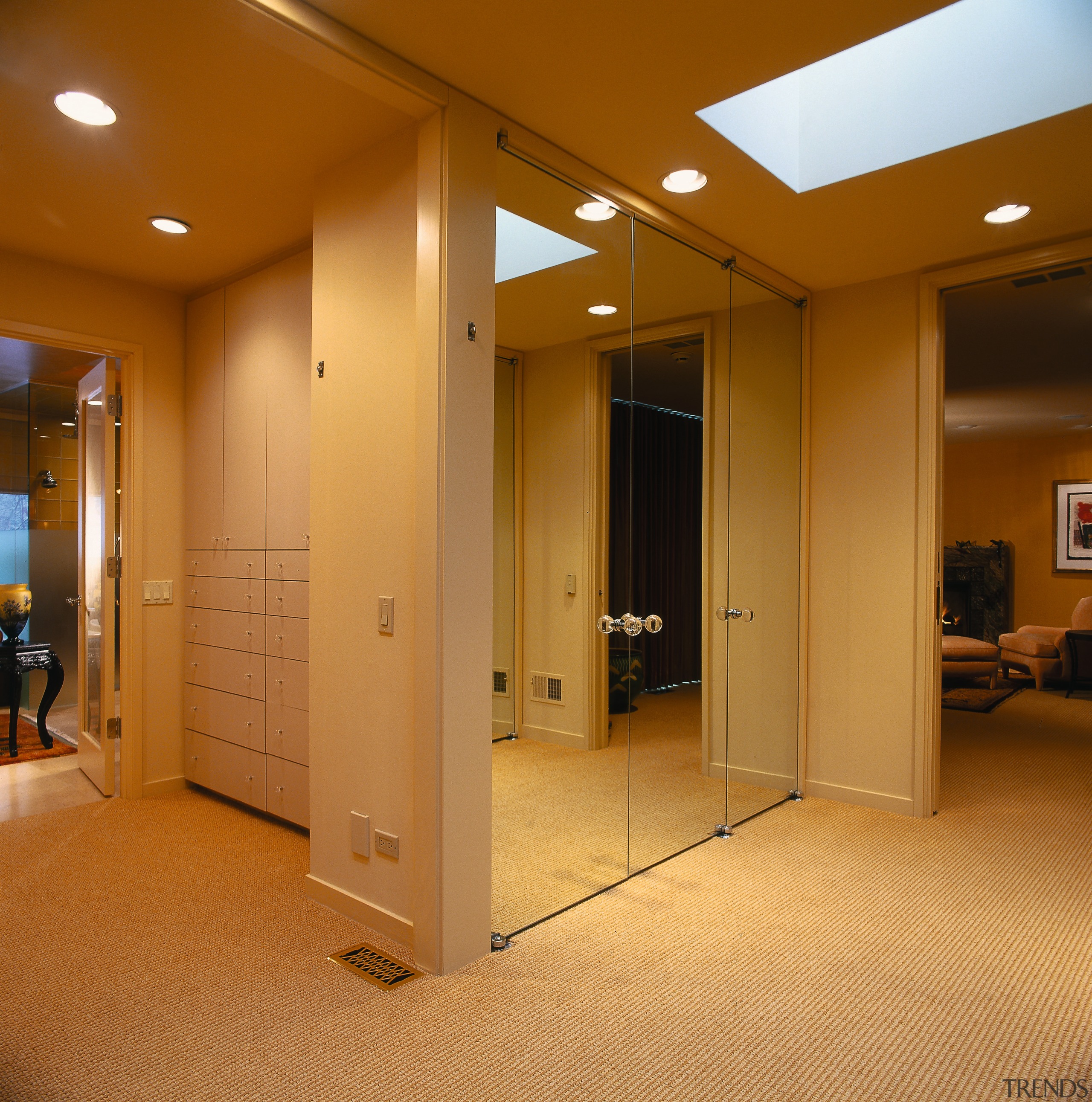 Mirrored closet doors line the passage to the ceiling, door, floor, flooring, interior design, lighting, lobby, room, brown, orange