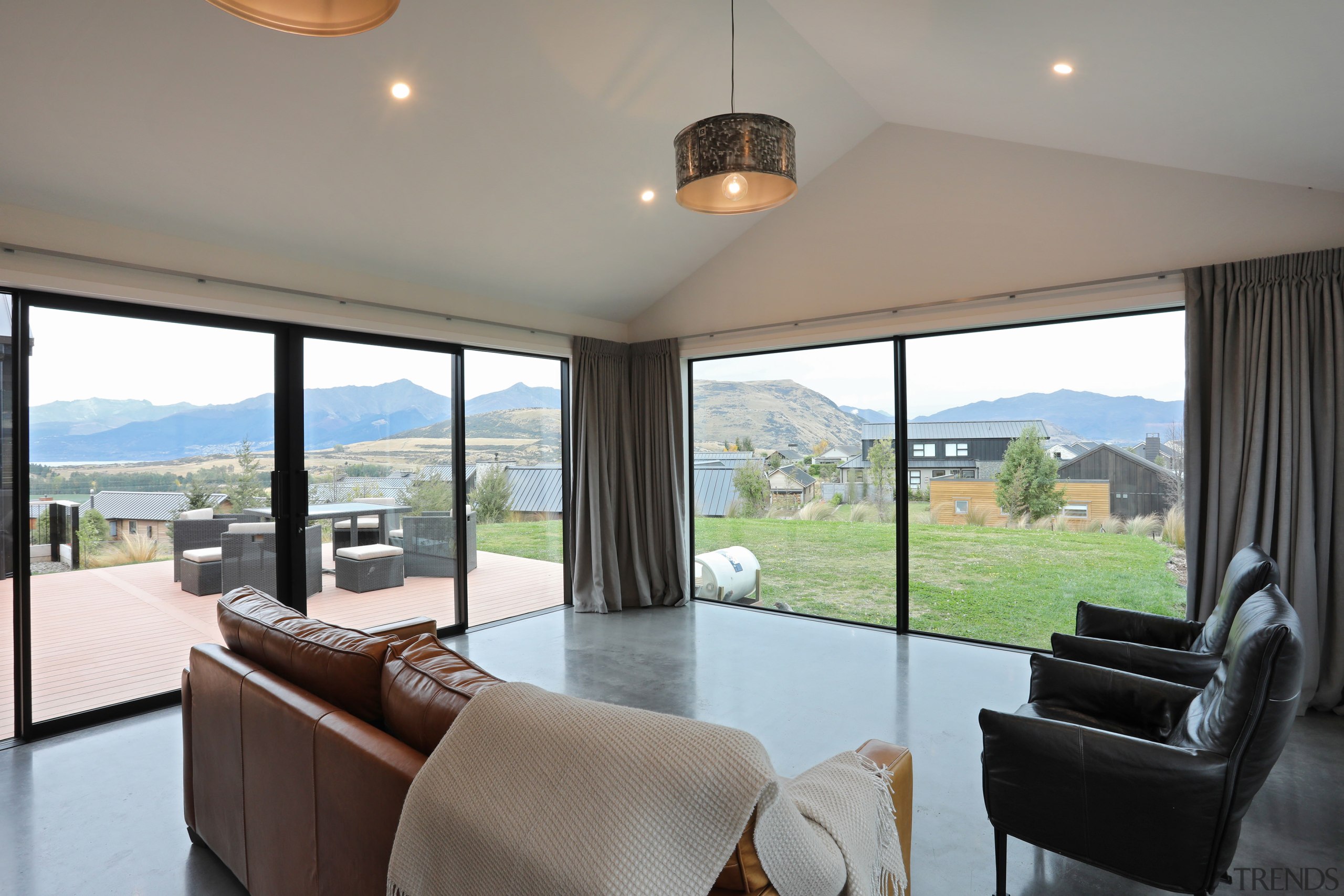 The open-plan living area at this Fowler Homes house, home, interior design, living room, windows, Fowler Homes, polished concrete floors