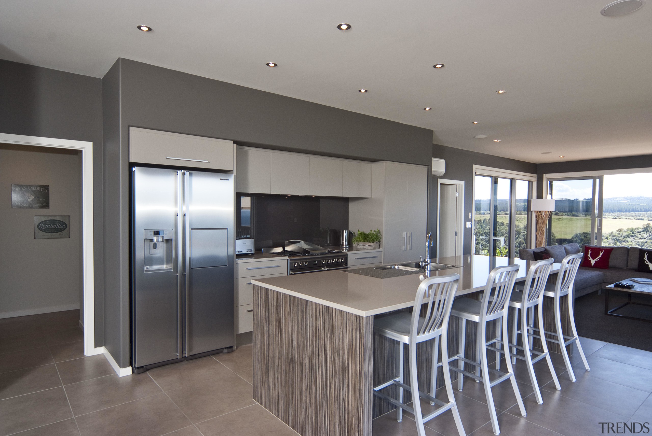 View of the kitchen area which features an countertop, floor, interior design, kitchen, property, real estate, gray