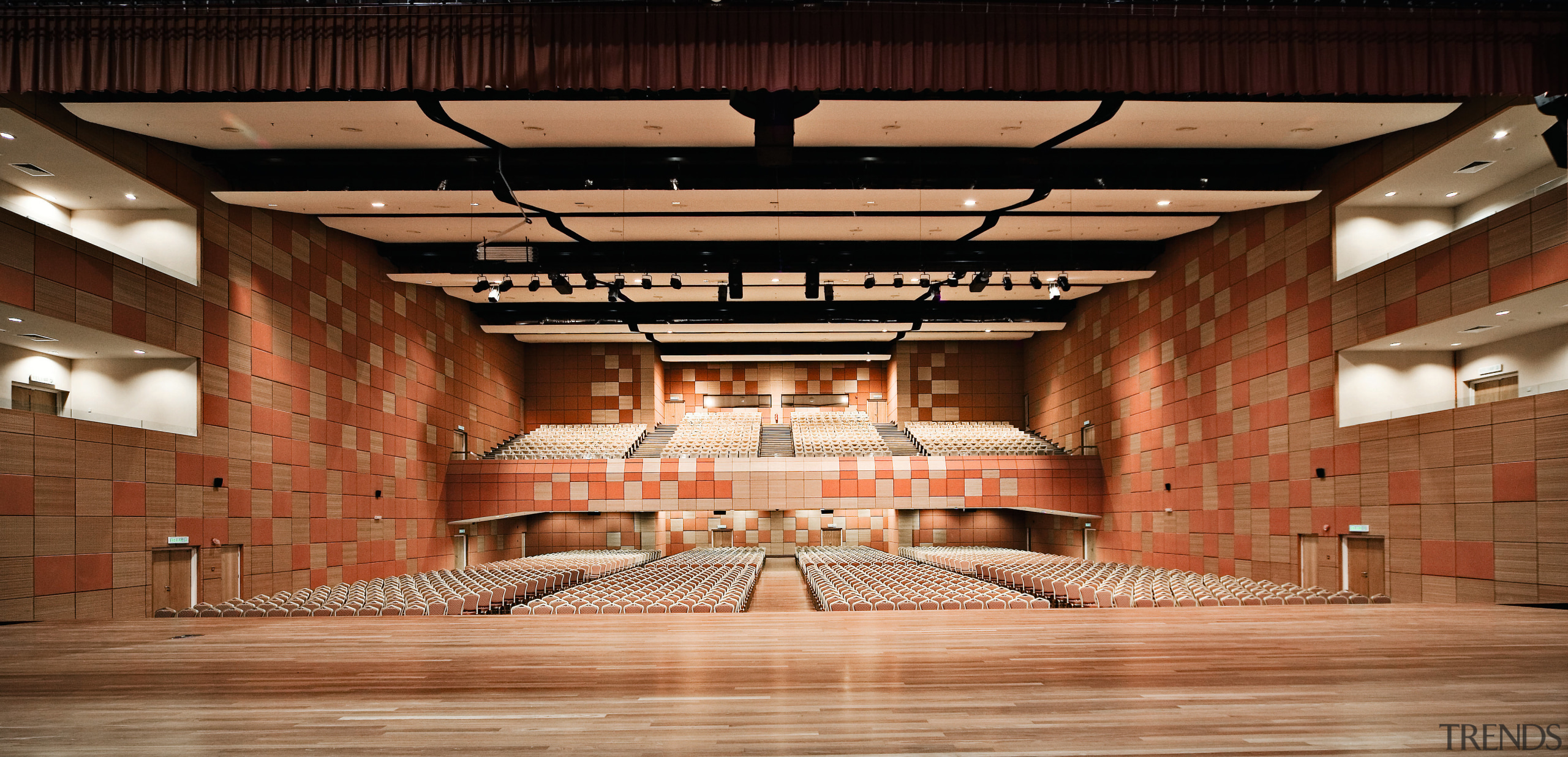 view of the stage and seating area in auditorium, performing arts center, theatre, brown, orange