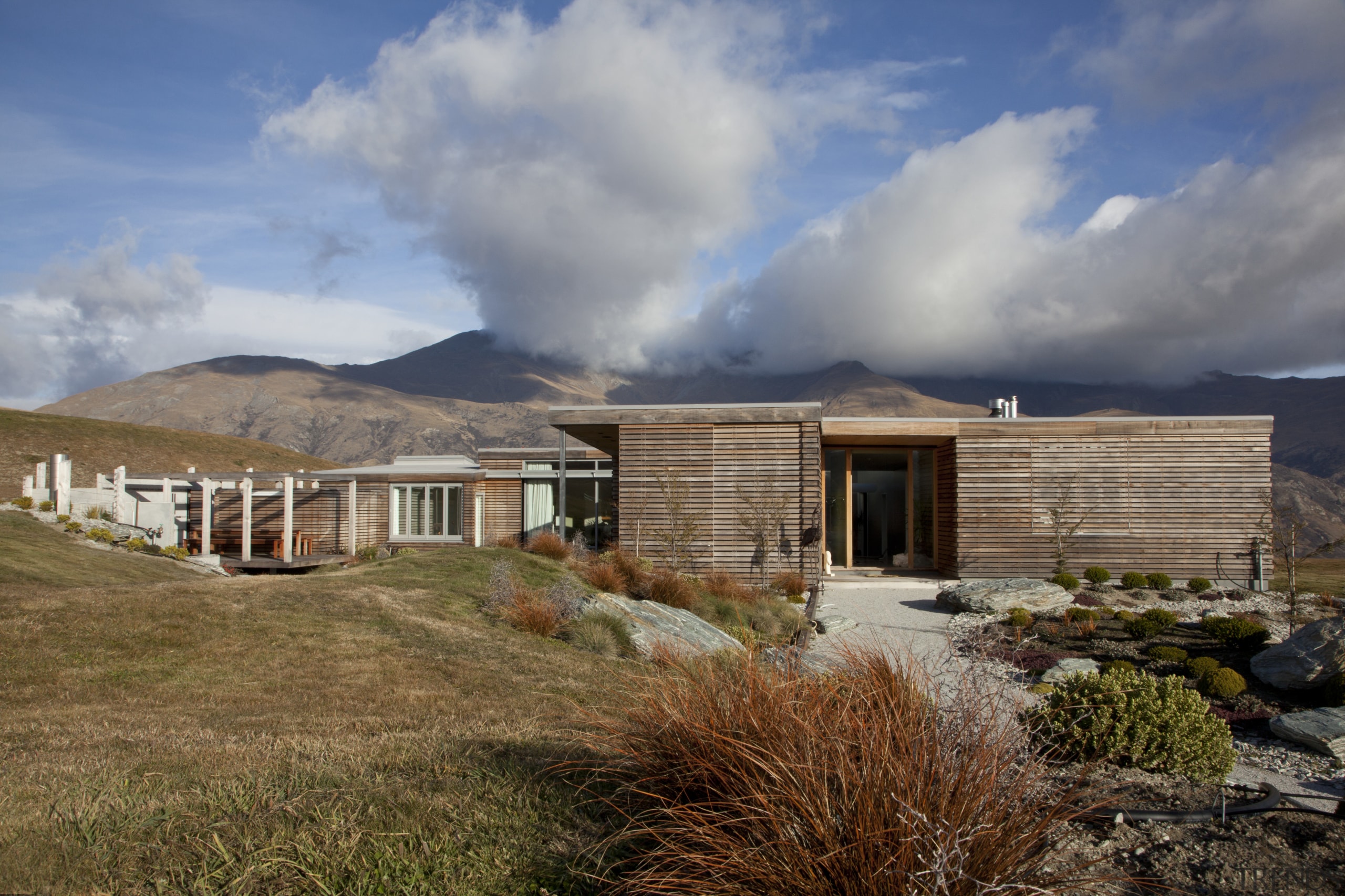 This home was designed by architect Nick Karlovsky. cloud, cottage, elevation, farmhouse, home, house, landscape, mountain, property, real estate, roof, sky, brown, gray