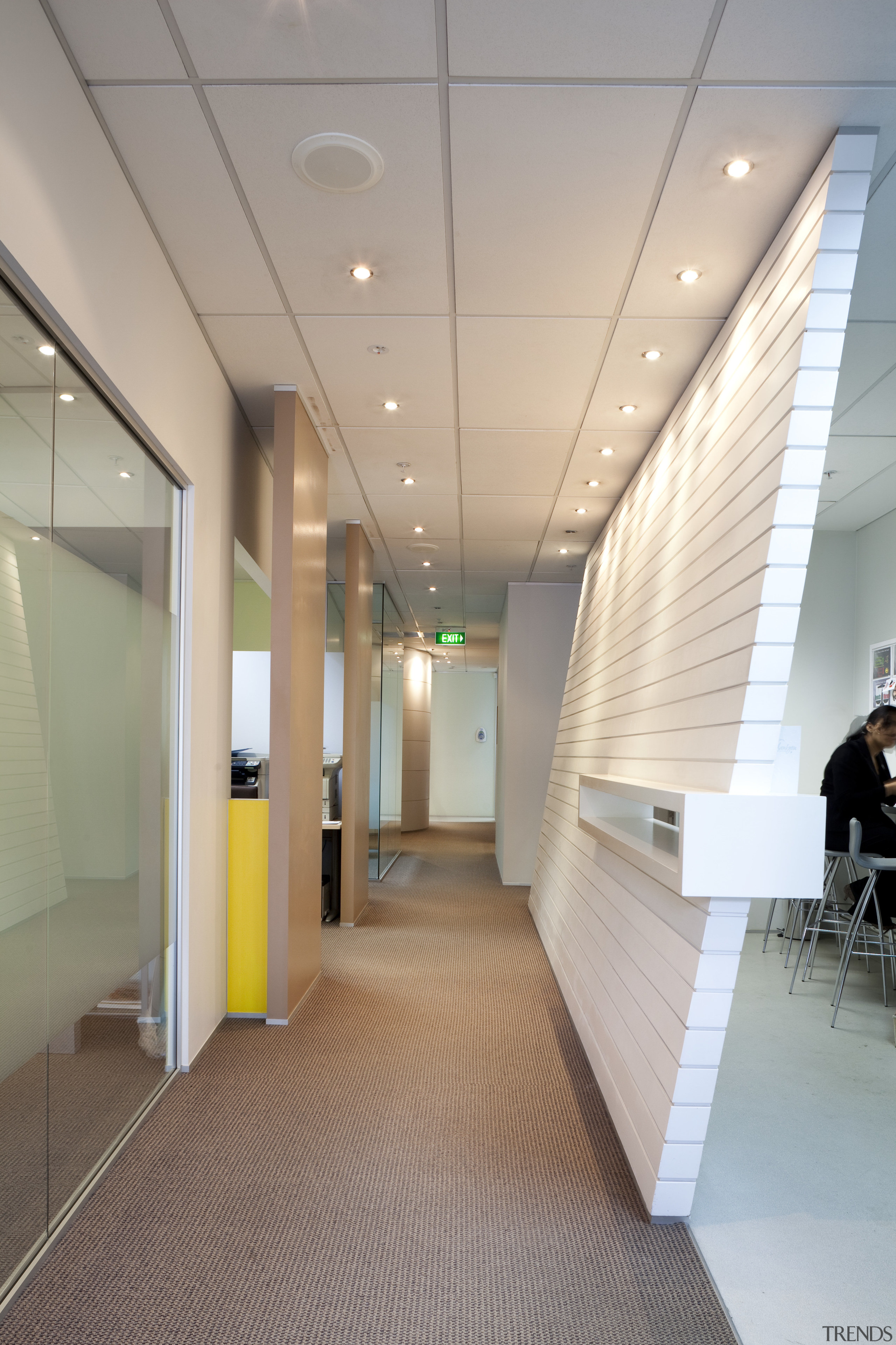 View of hallway with slanted white wall. - architecture, ceiling, daylighting, floor, flooring, glass, interior design, lobby, office, gray