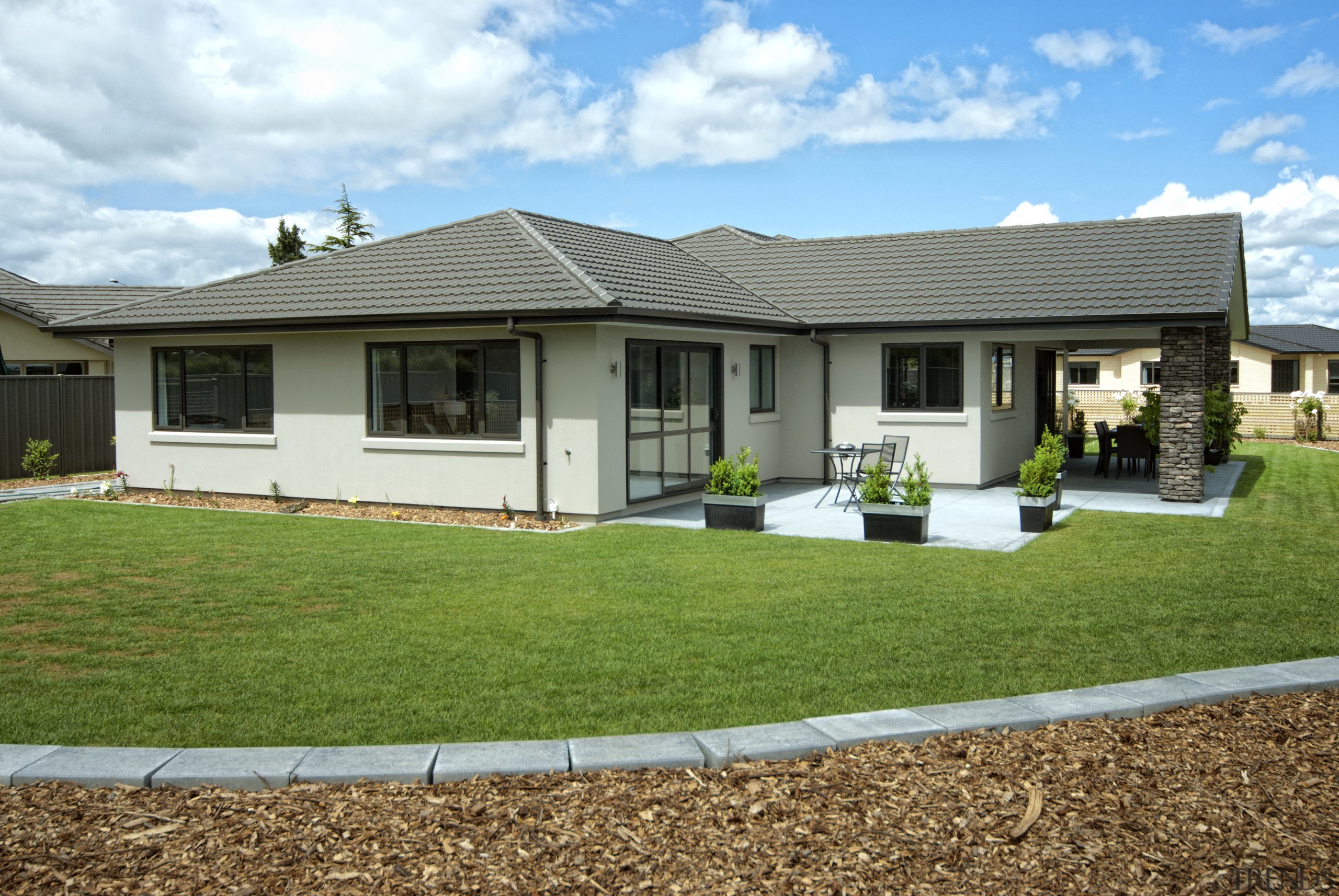 Exterior view of David Reid show home which backyard, cottage, elevation, estate, facade, farmhouse, grass, home, house, land lot, landscape, lawn, property, real estate, residential area, roof, siding, suburb, window, yard