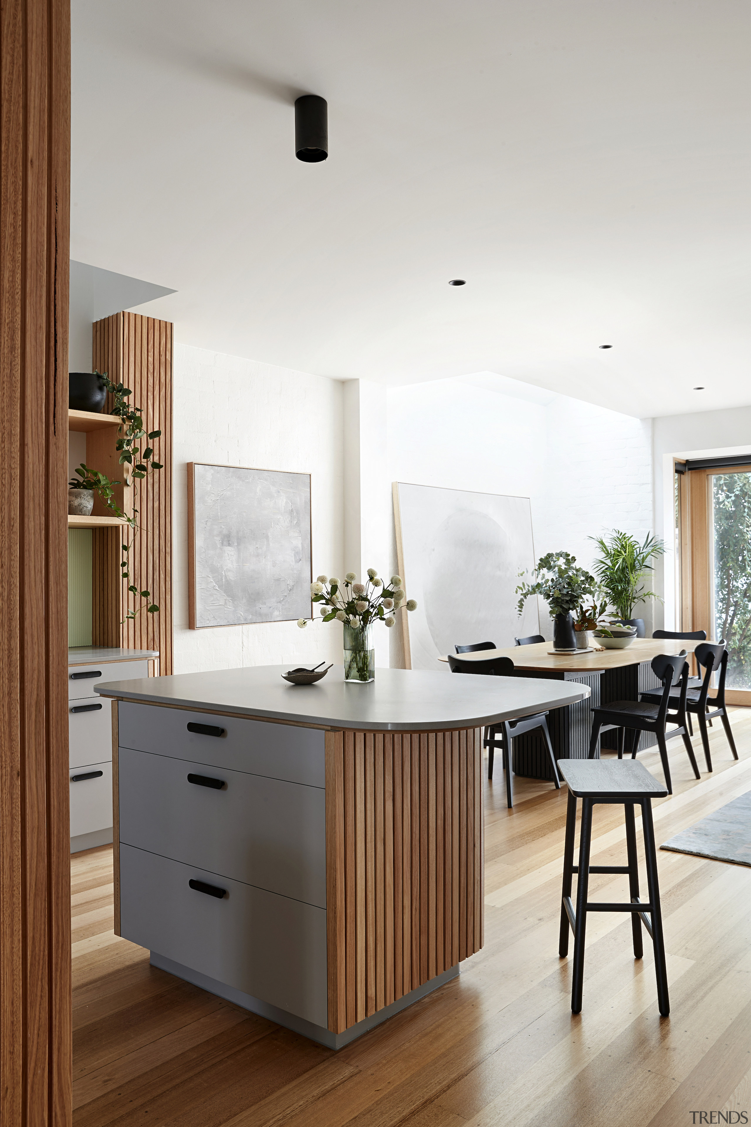 Vic Ash floors connect with the batten cabinetry 