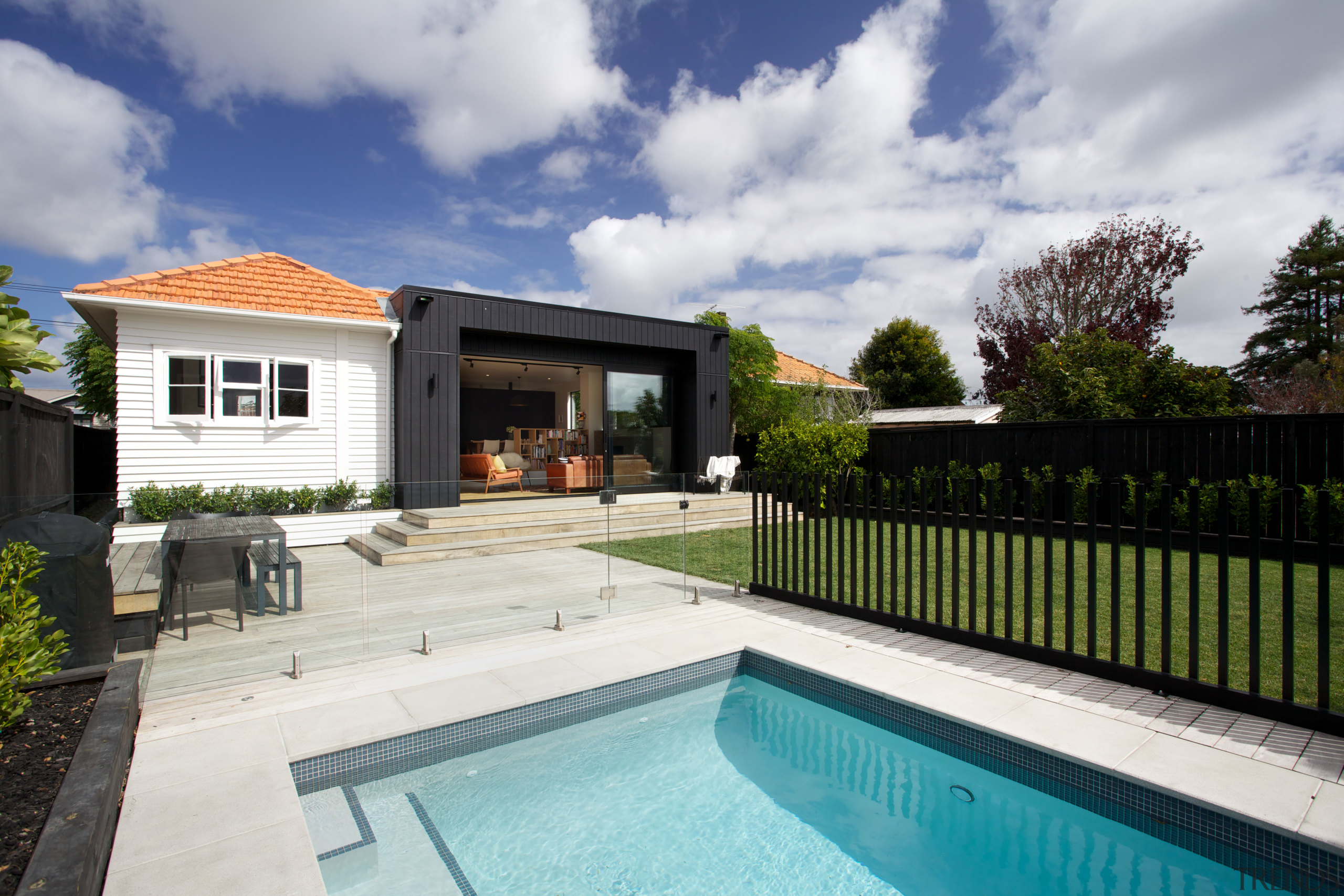 Contemporary black box addition to older home the backyard, estate, facade, home, house, outdoor structure, property, real estate, residential area, swimming pool, villa, gray