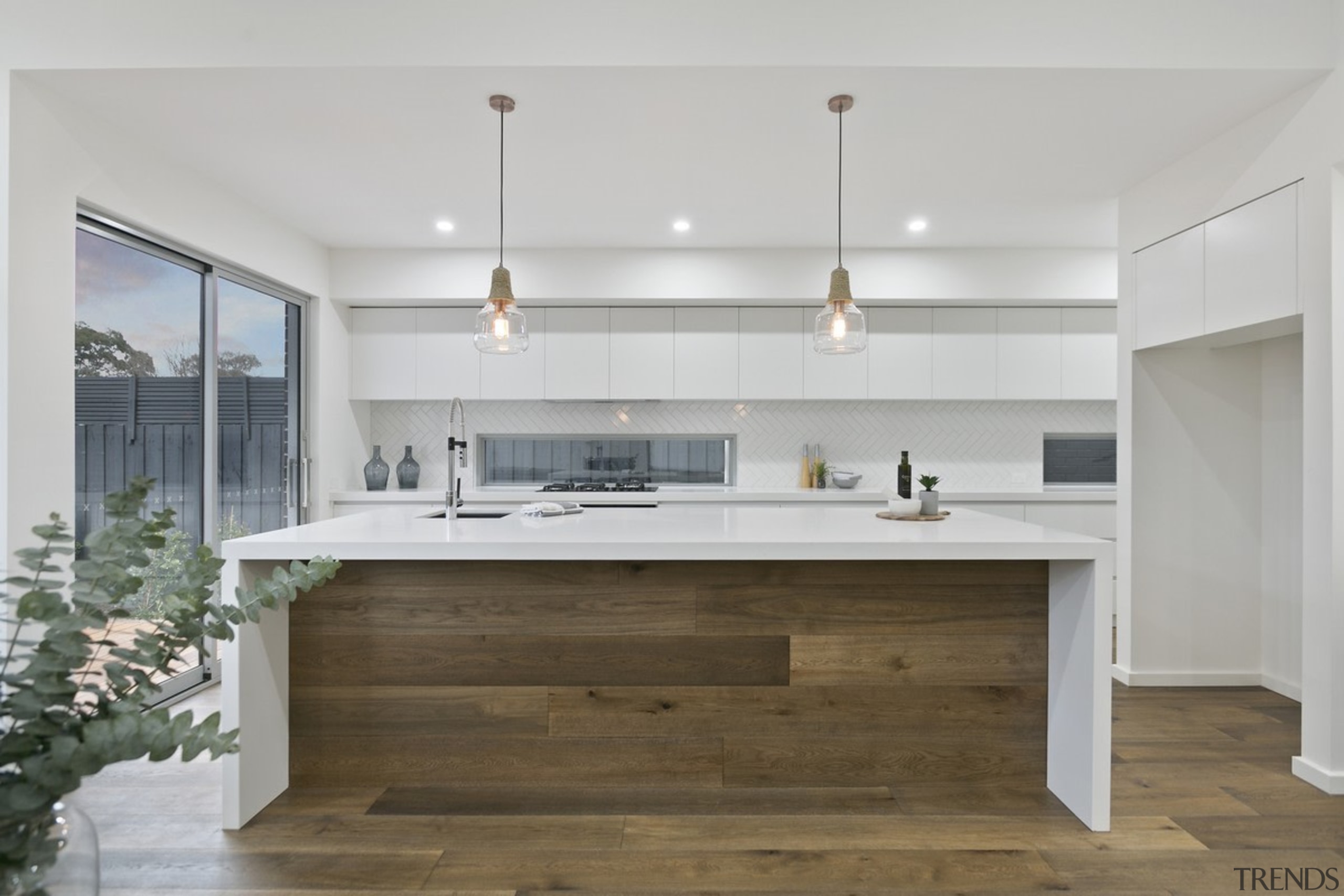 Pendant lights hang down over the island - architecture, cabinetry, countertop, cuisine classique, floor, interior design, kitchen, gray, brown