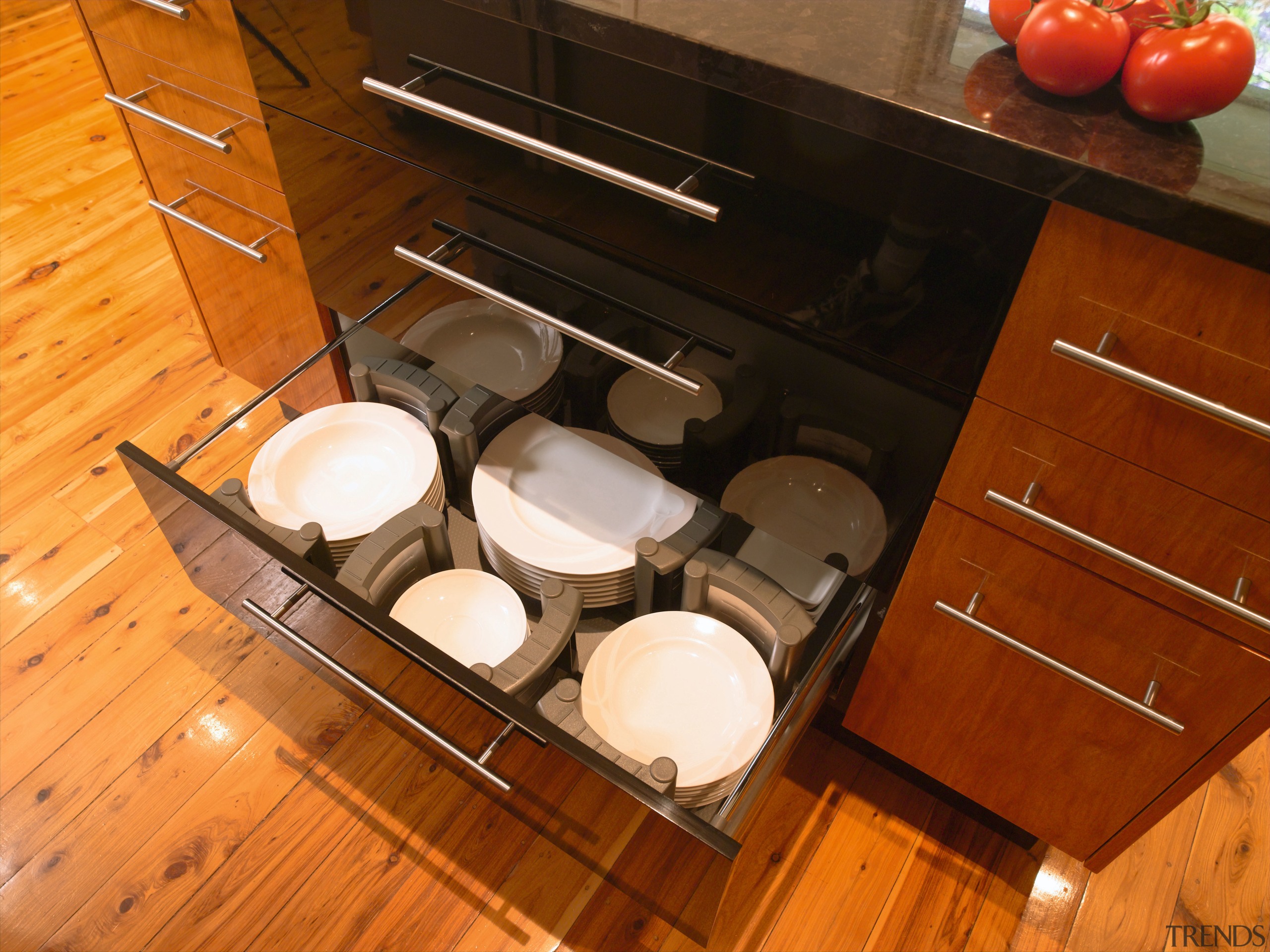 Kitchen with view of island drawers. - Kitchen cabinetry, countertop, drawer, floor, flooring, furniture, hardwood, kitchen, kitchen organizer, room, table, wood, brown, orange