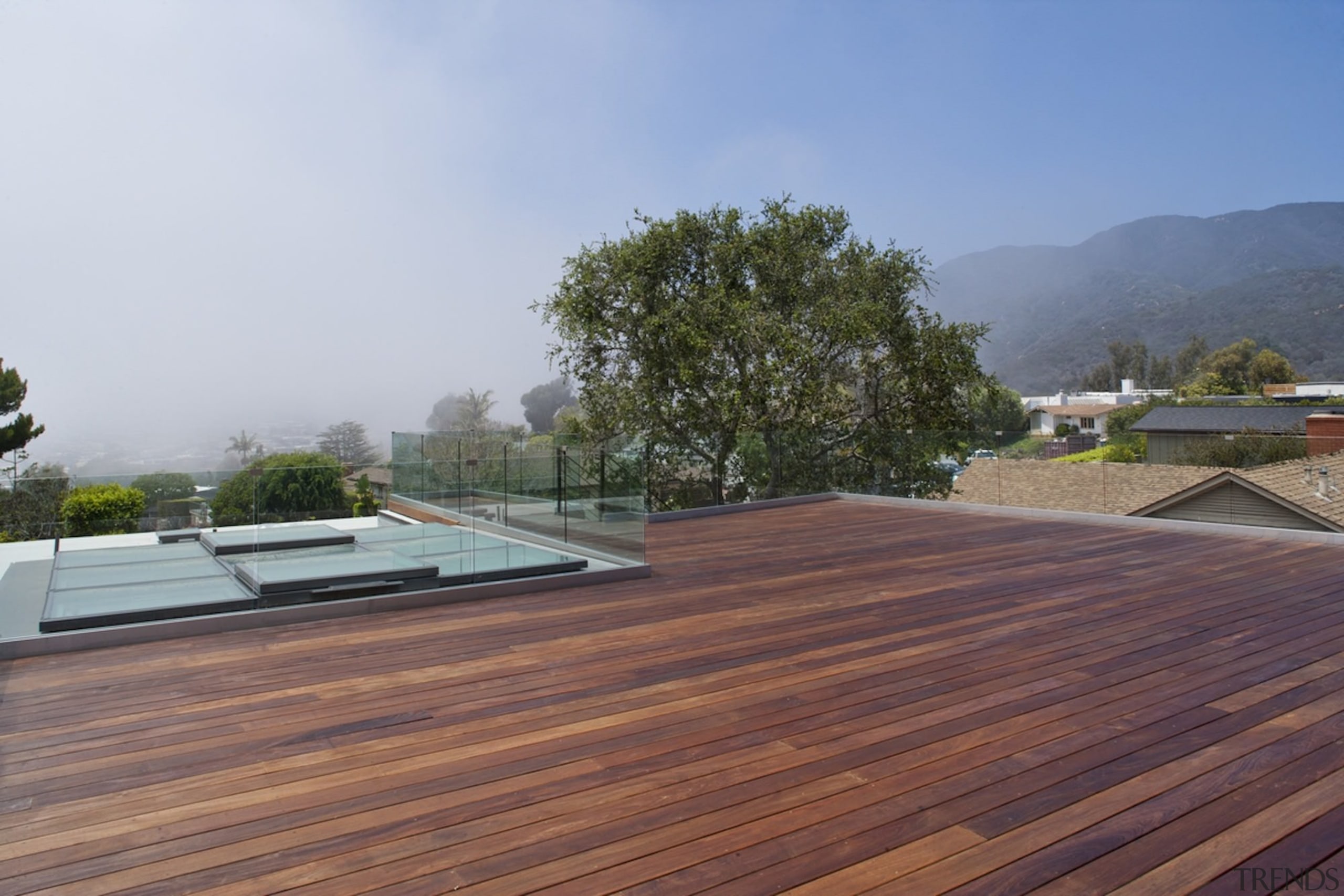 You can glimpse the mountains from this deck architecture, daylighting, deck, floor, house, outdoor structure, property, real estate, roof, wood, gray, red