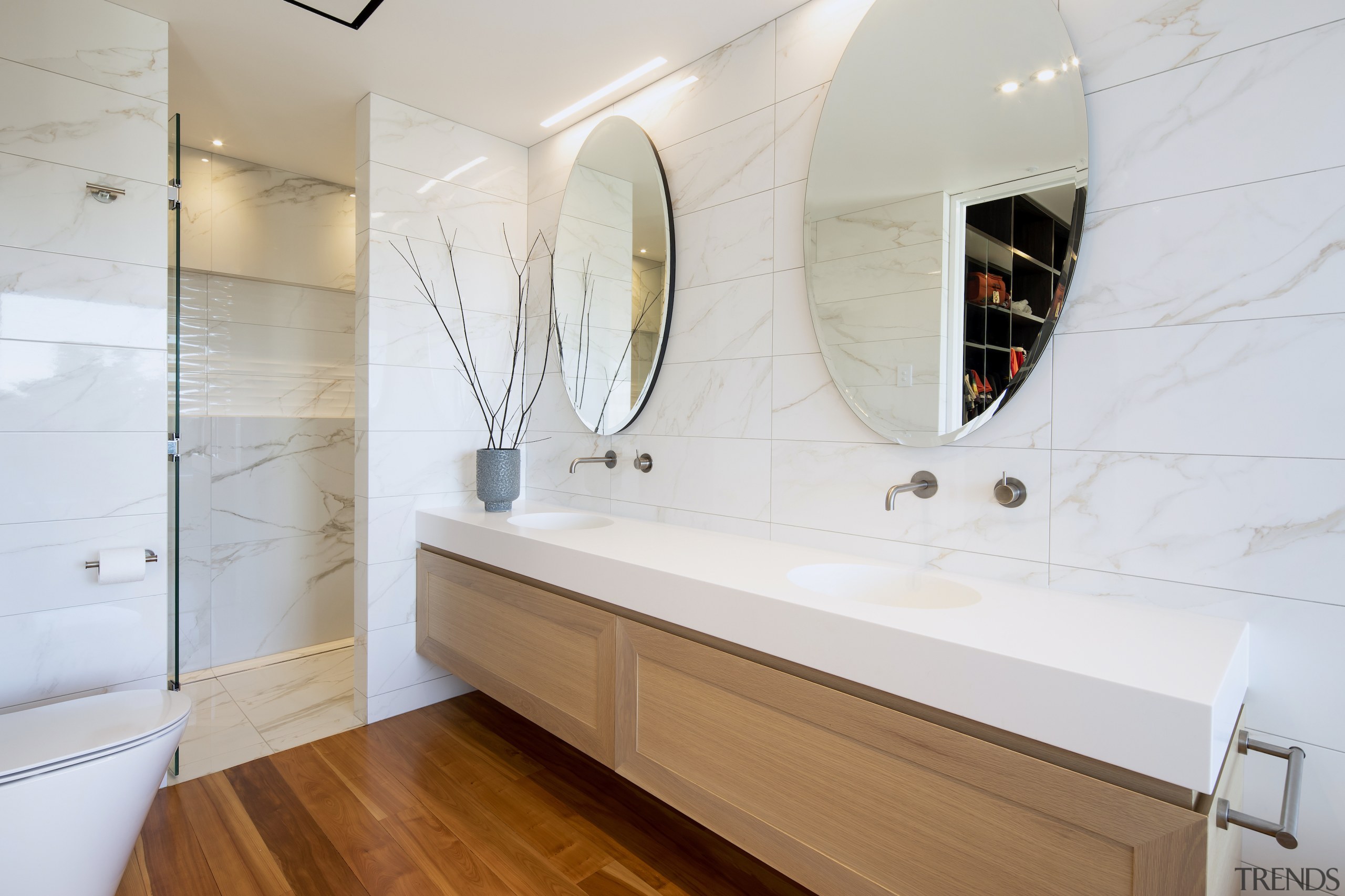 The custom shower stall has a central glass 