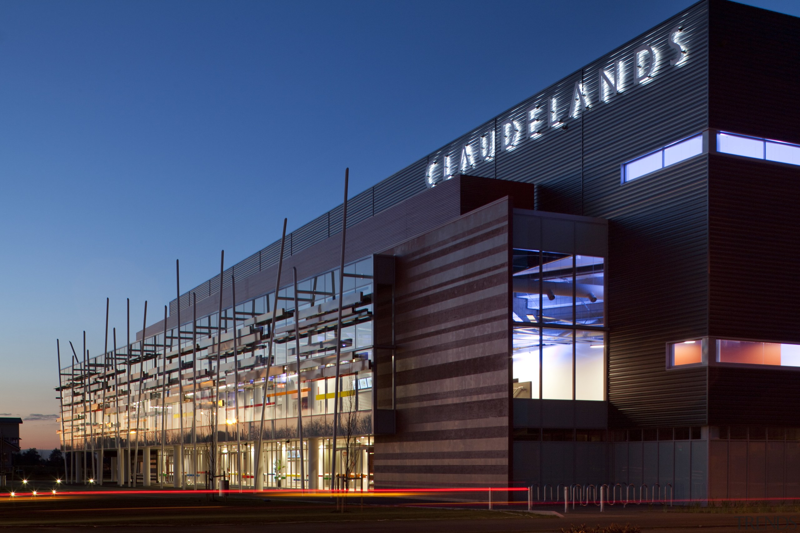 The Claudelands arena was redesigned by Chow of architecture, building, commercial building, convention center, corporate headquarters, facade, headquarters, infrastructure, metropolis, metropolitan area, mixed use, night, sky, structure, blue