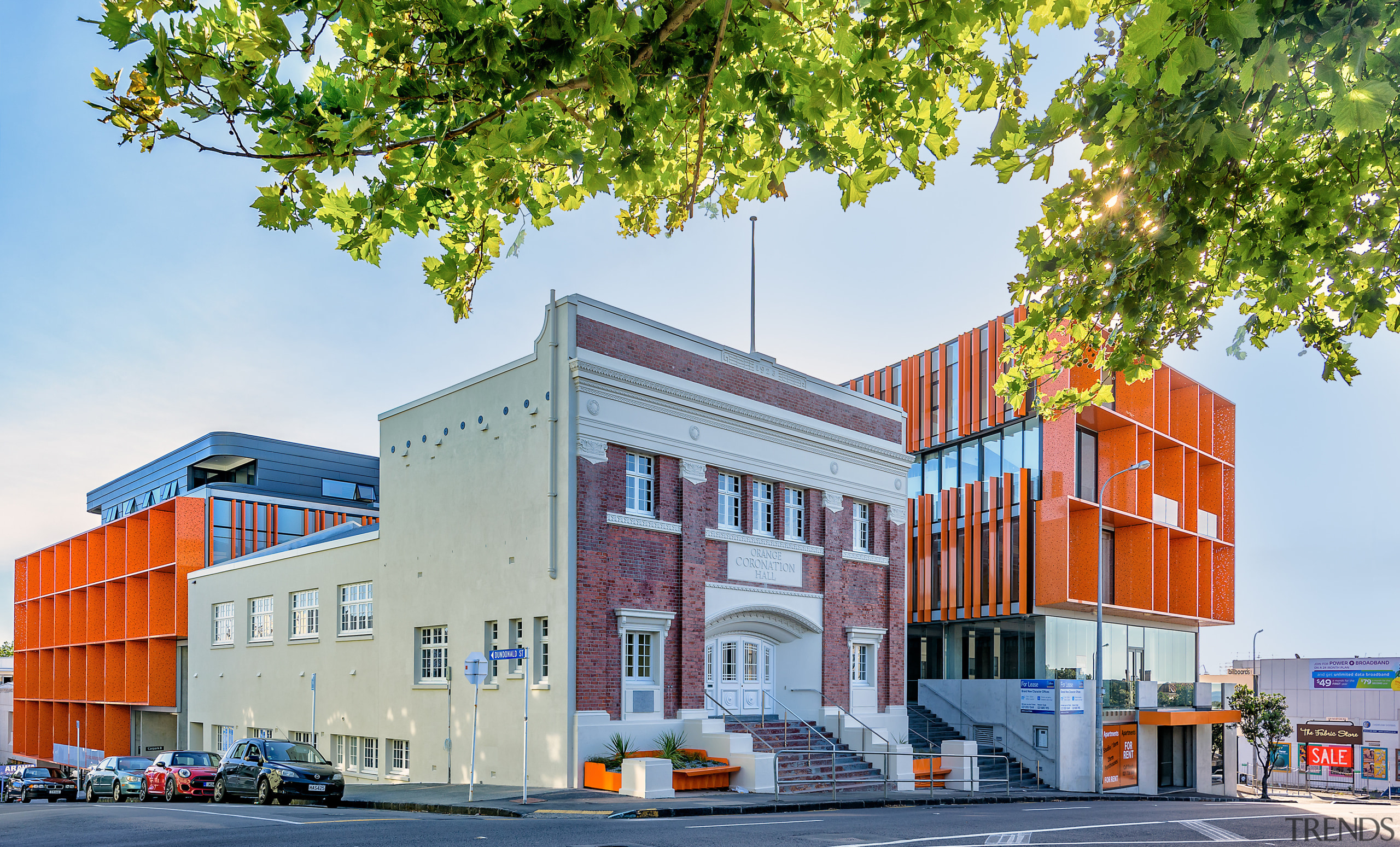 The Orange is a mixed-use Auckland development combining apartment, architecture, building, city, commercial building, elevation, facade, home, house, metropolitan area, mixed use, neighbourhood, real estate, residential area, white