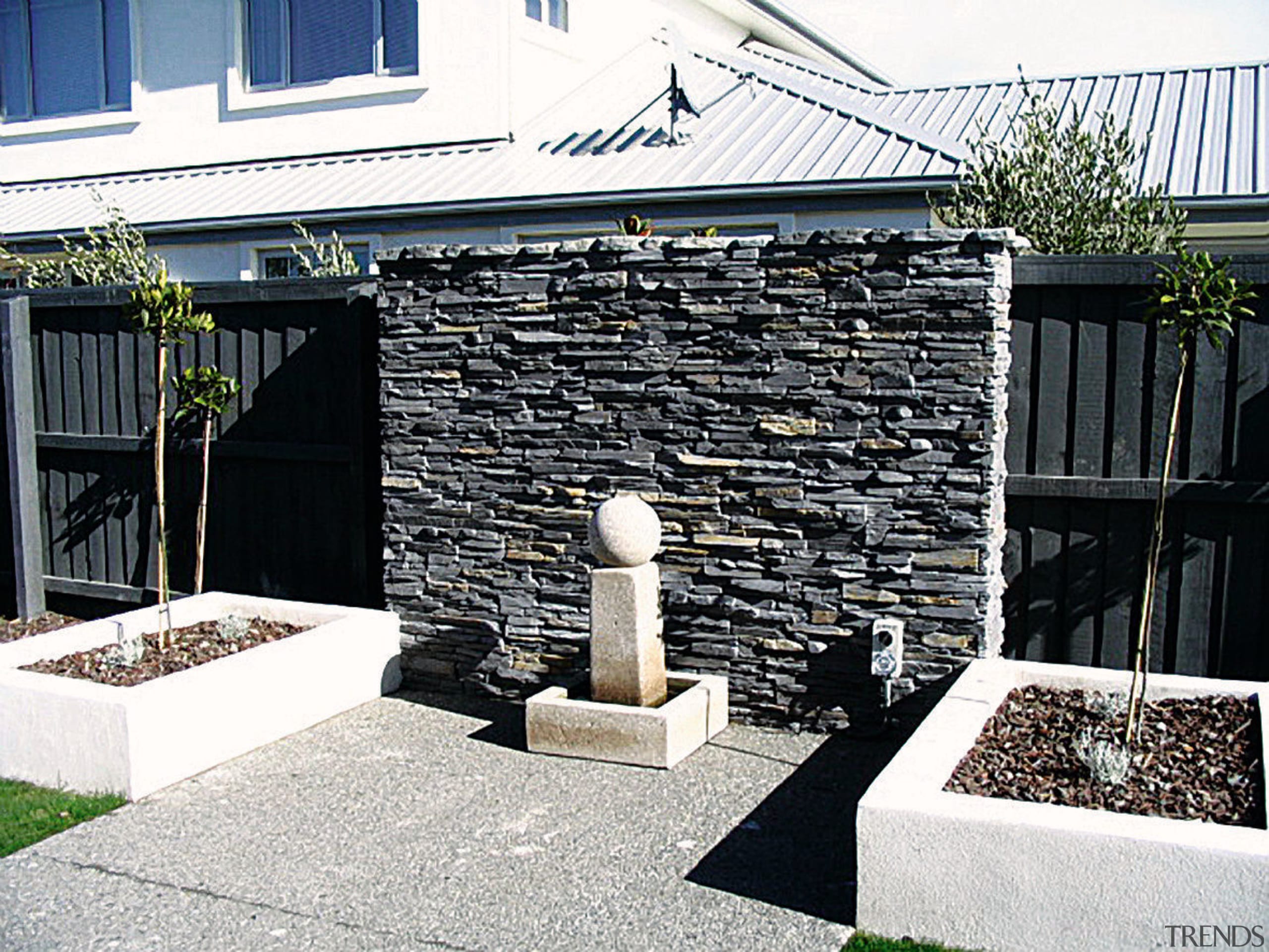 view of the stone veneers  that are courtyard, outdoor structure, property, roof, stone wall, walkway, wall, white, black