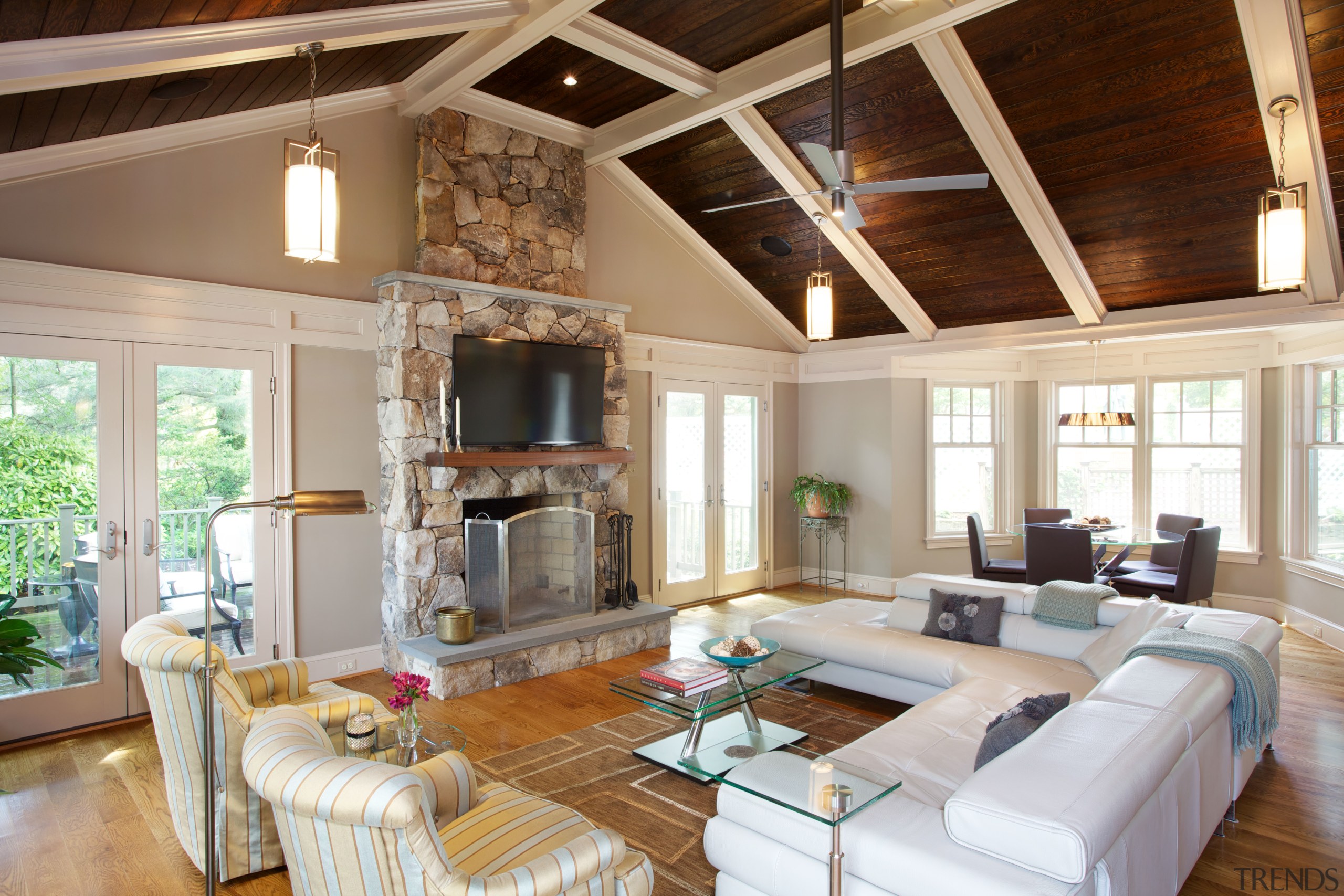 The double-height family room features a stained wood beam, ceiling, estate, home, interior design, living room, real estate, room, window, brown, gray