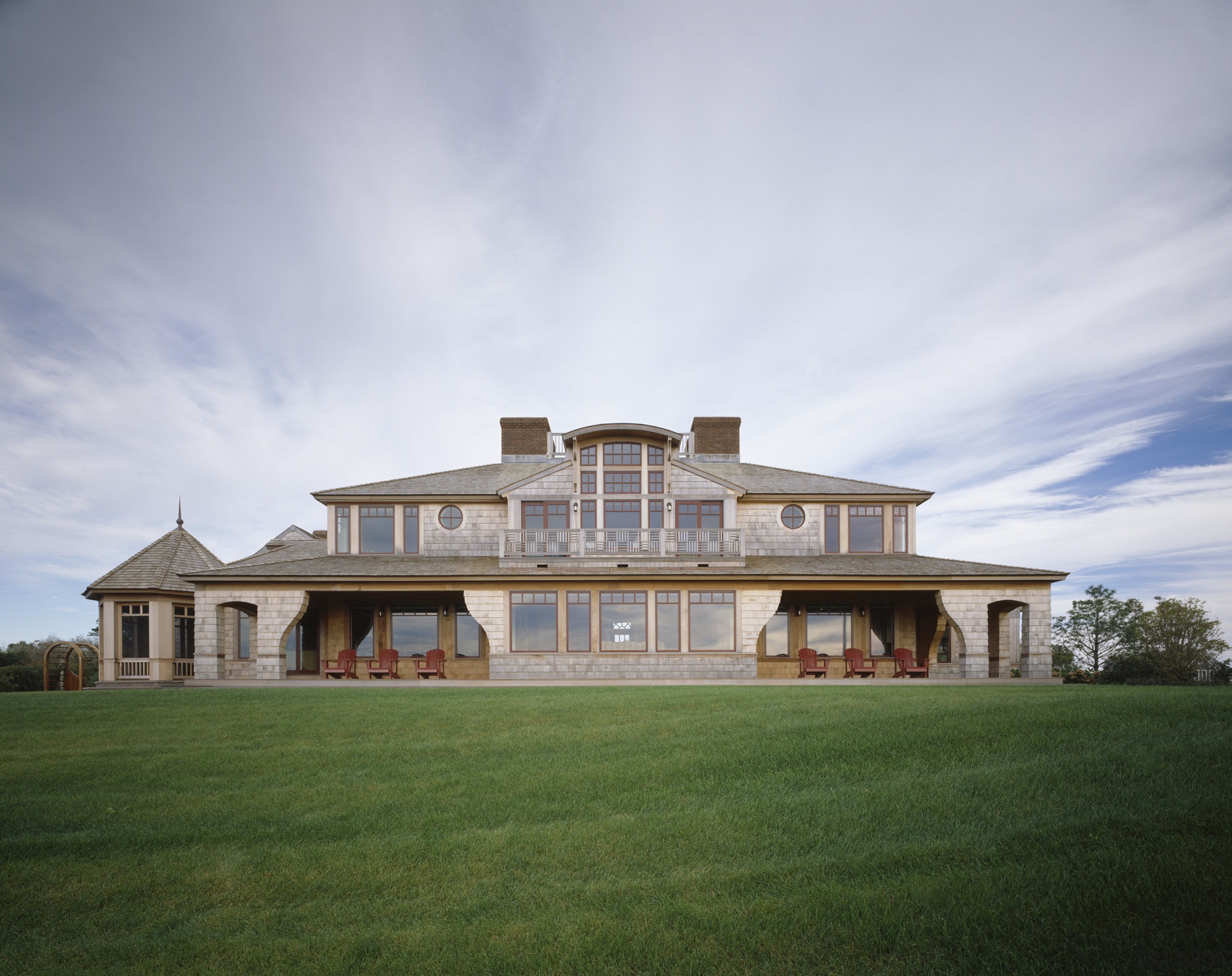 Exterior view of a large cottage with cedar cloud, cottage, elevation, estate, facade, farmhouse, grass, home, house, lawn, mansion, property, real estate, residential area, roof, sky, villa, gray