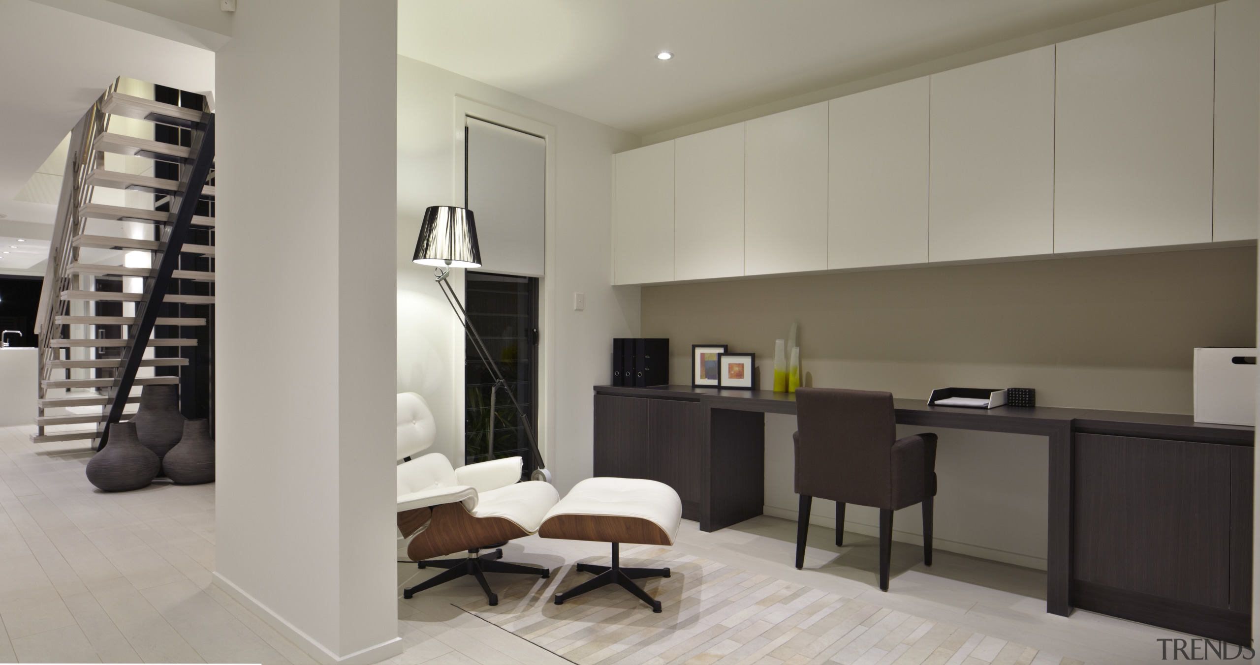Desk area with cream cupboards and brown chair. floor, flooring, interior design, living room, room, gray