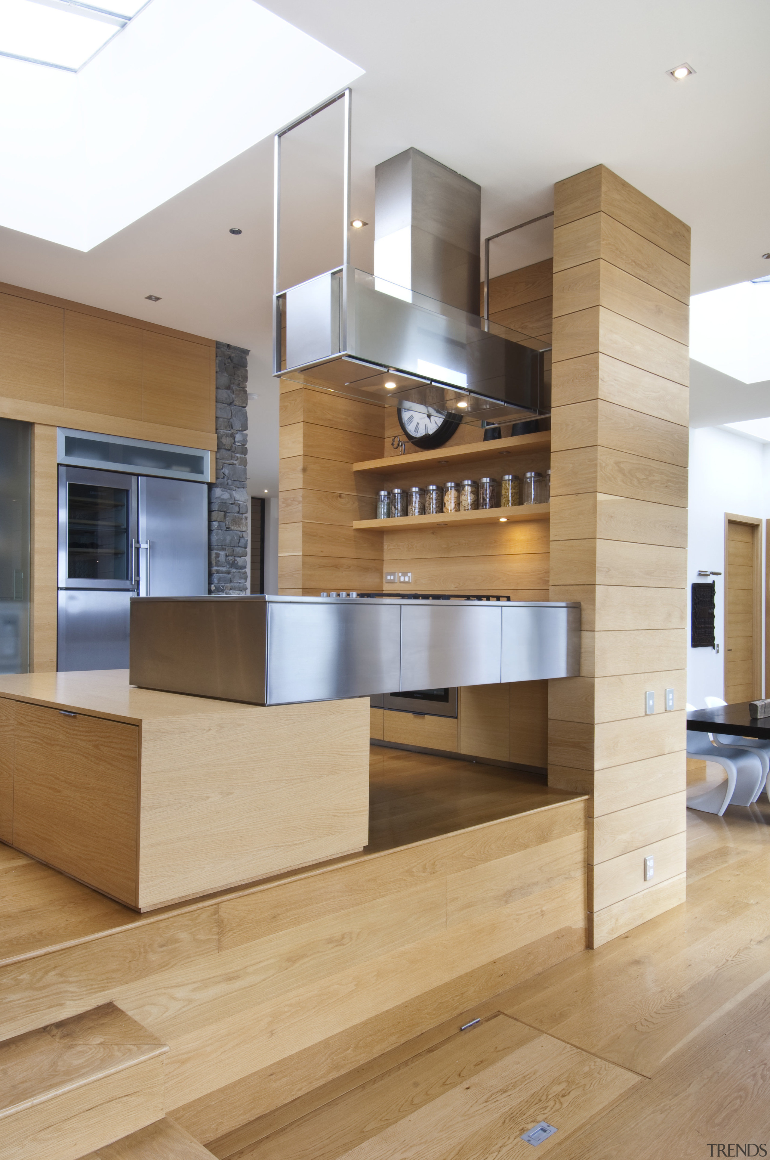 Raised floor kitchen. Stainless steel Binova cooktop. American cabinetry, floor, flooring, furniture, hardwood, interior design, kitchen, wood, wood flooring, orange