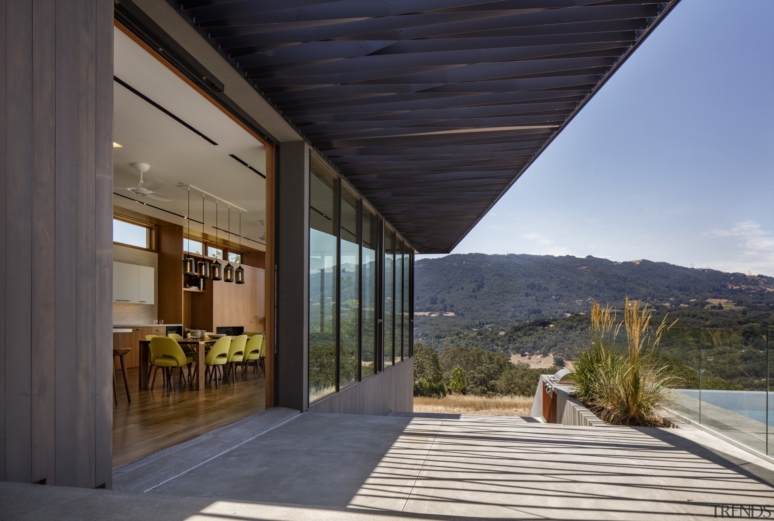 Sliding glass panels fully open up the kitchen apartment, architecture, home, house, real estate, roof, sky, black