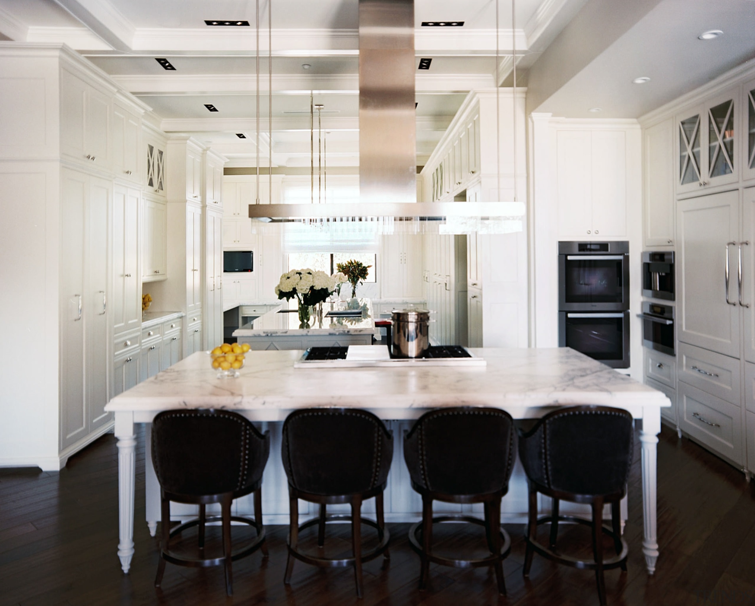 Black bar stools and a dark walnut floor cabinetry, countertop, cuisine classique, dining room, floor, flooring, interior design, kitchen, room, wood flooring, white, black