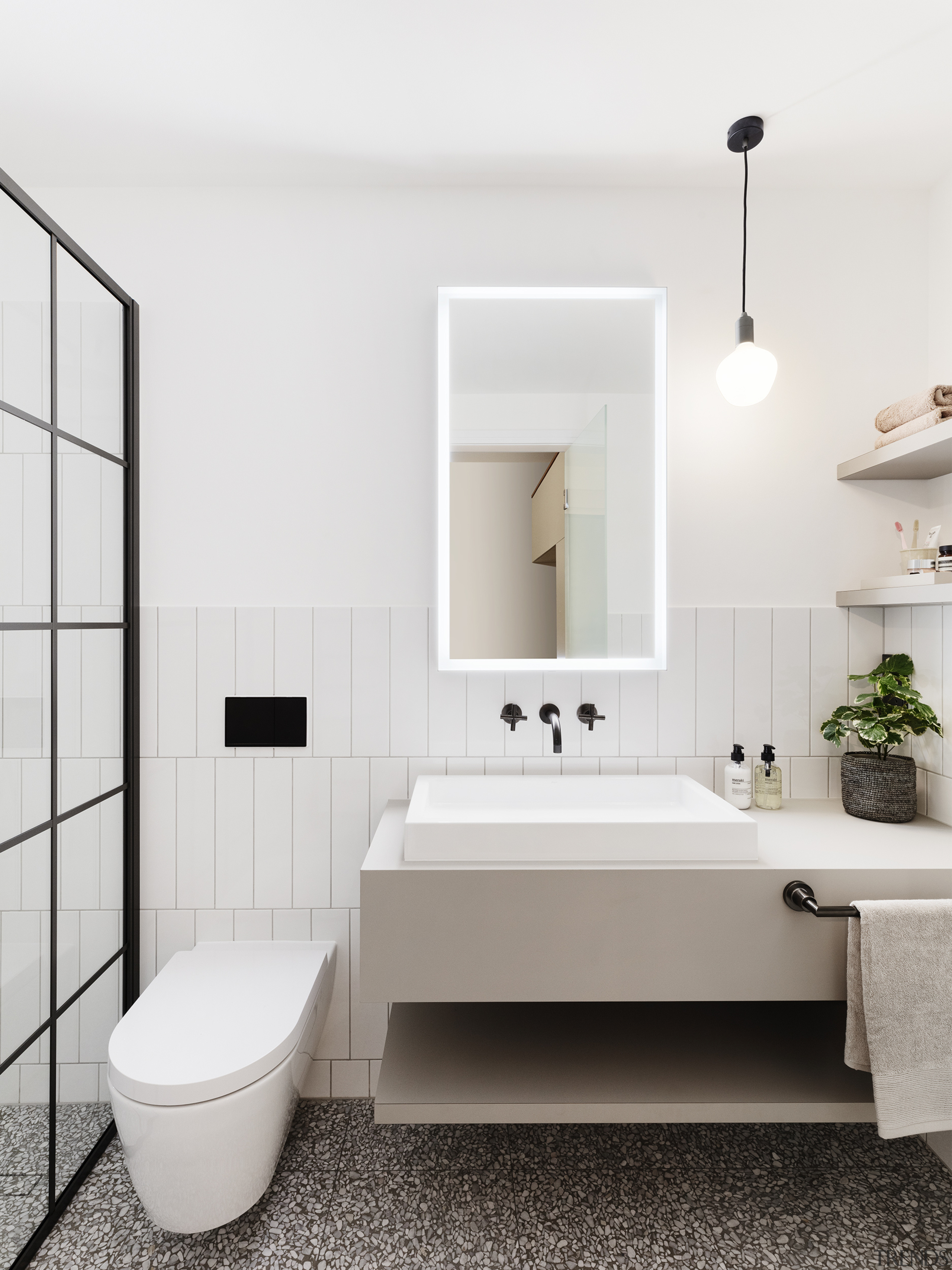 In the smaller, children's ensuite a striking terrazzo 