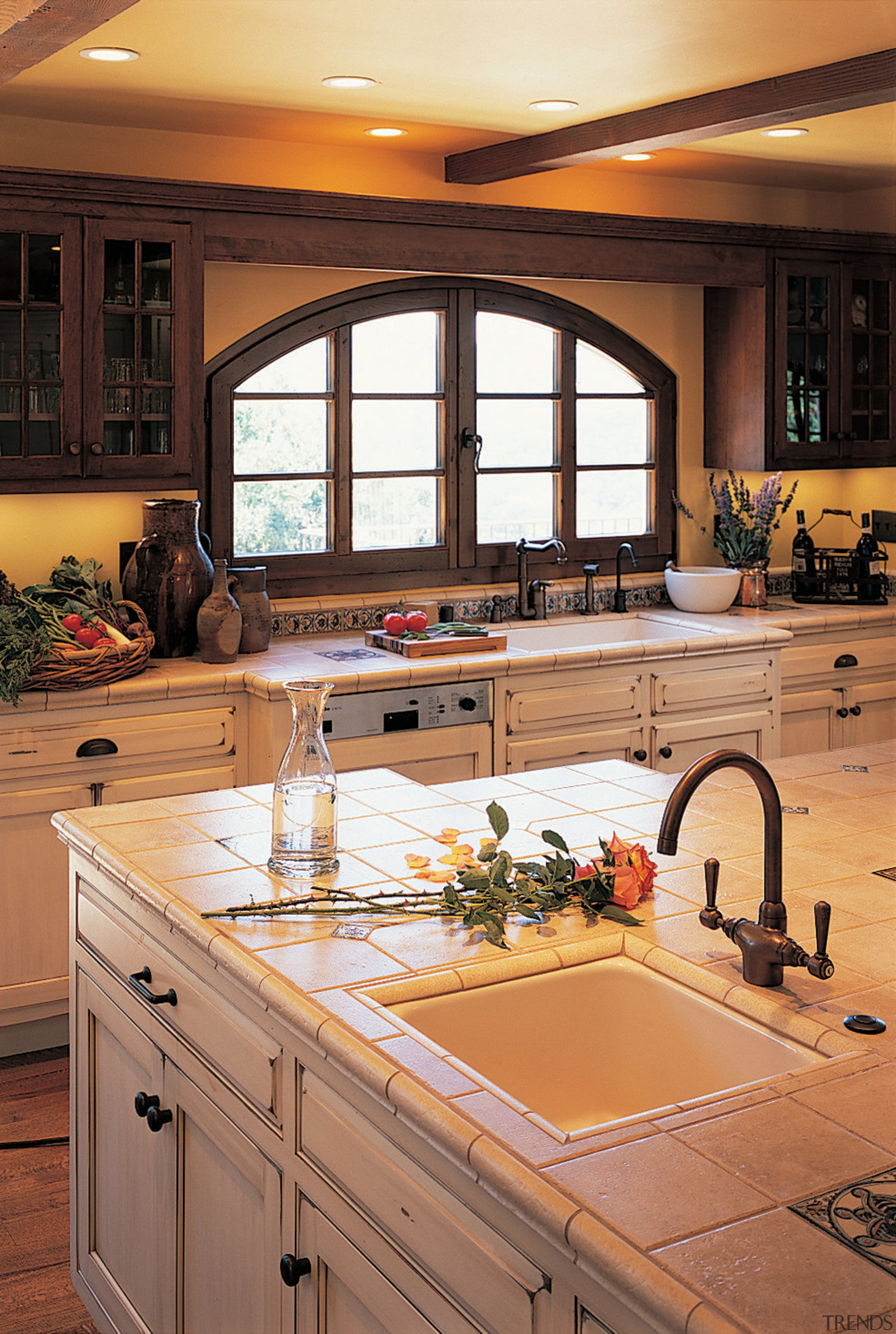 A corner of this well-designed traditional kitchen cabinetry, countertop, cuisine classique, home, interior design, kitchen, room, table, under cabinet lighting, window, orange, brown