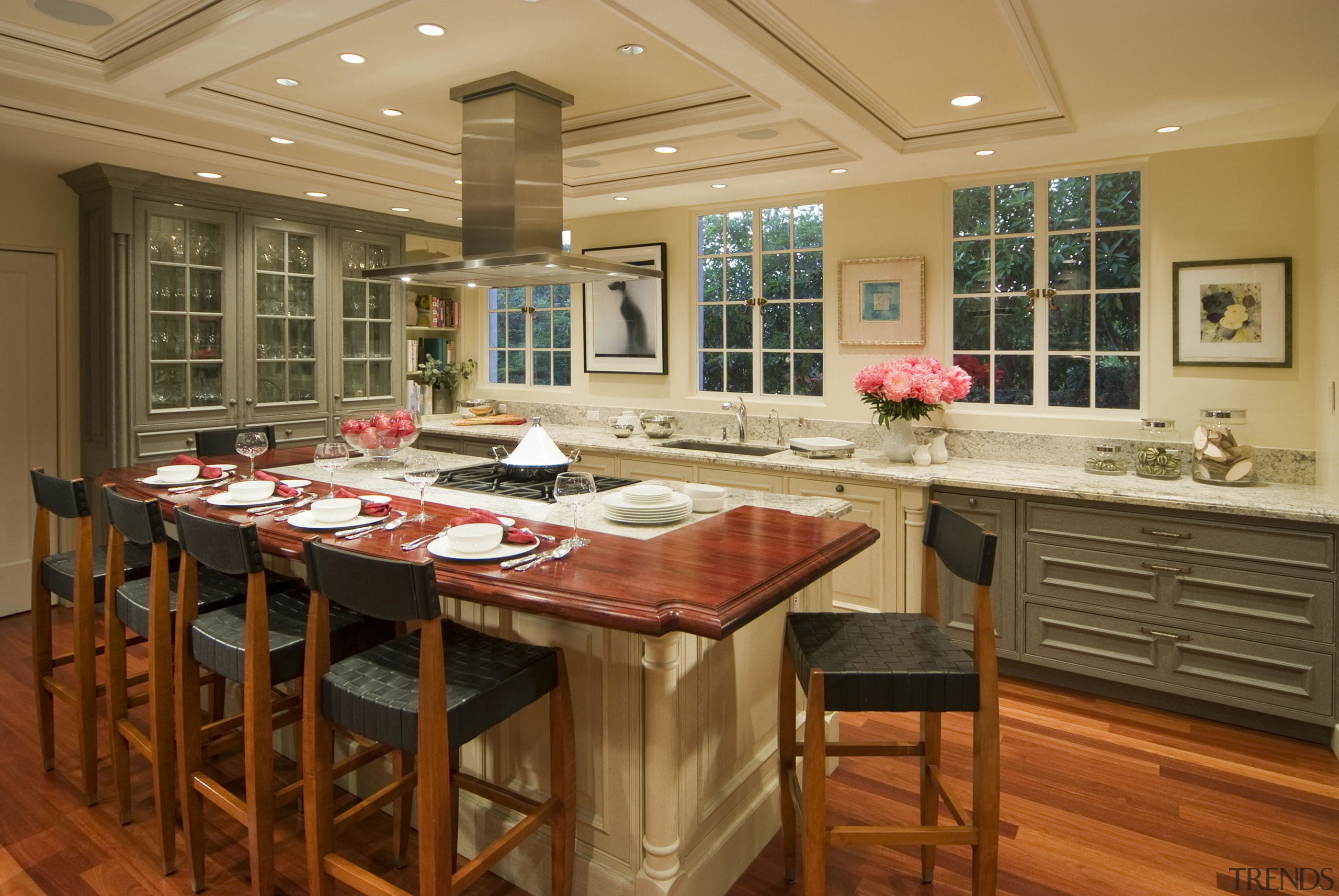 View of a French-styled kitchen featuring island, granite cabinetry, countertop, cuisine classique, interior design, kitchen, room, brown, orange