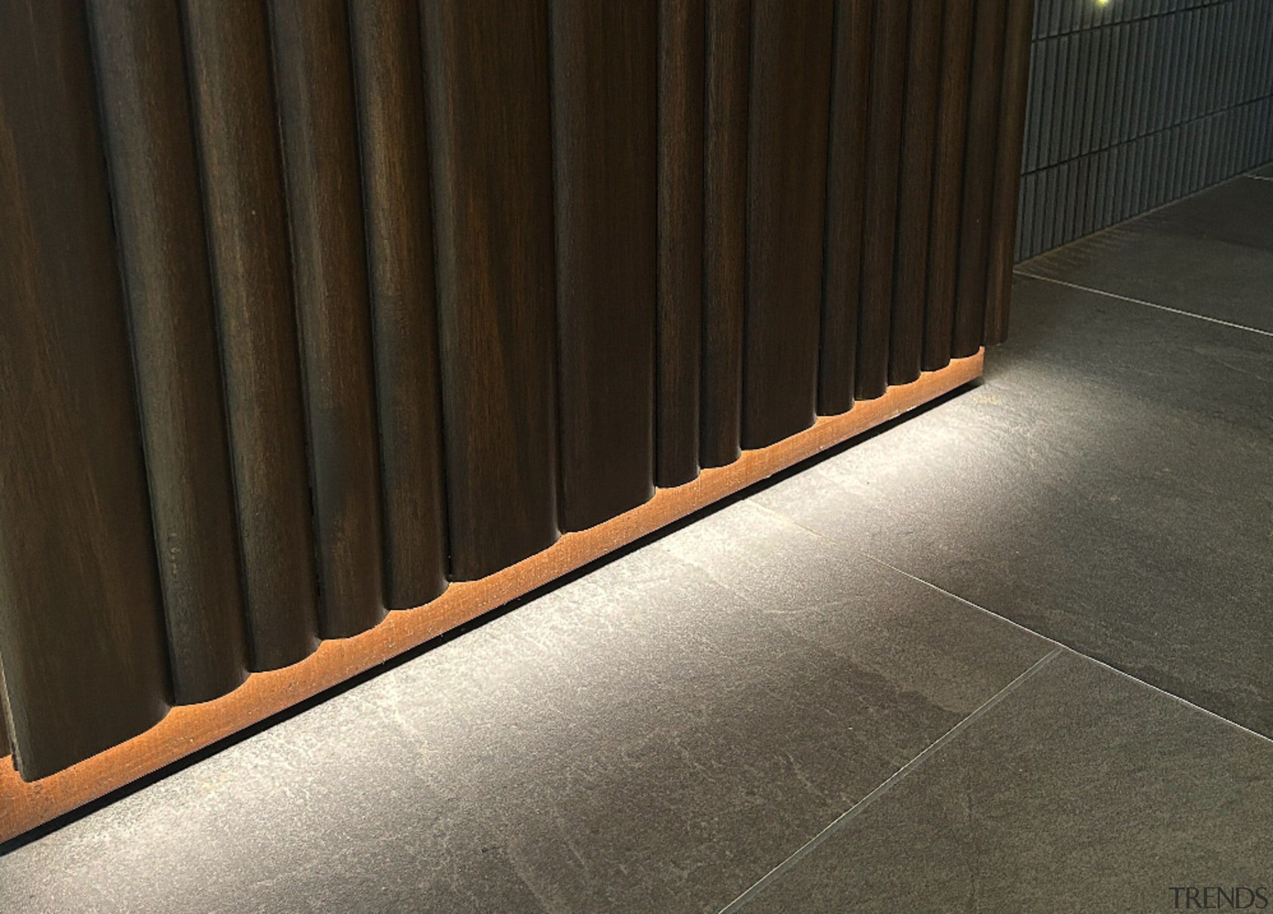 Concealed lighting highlights the wall finish. 