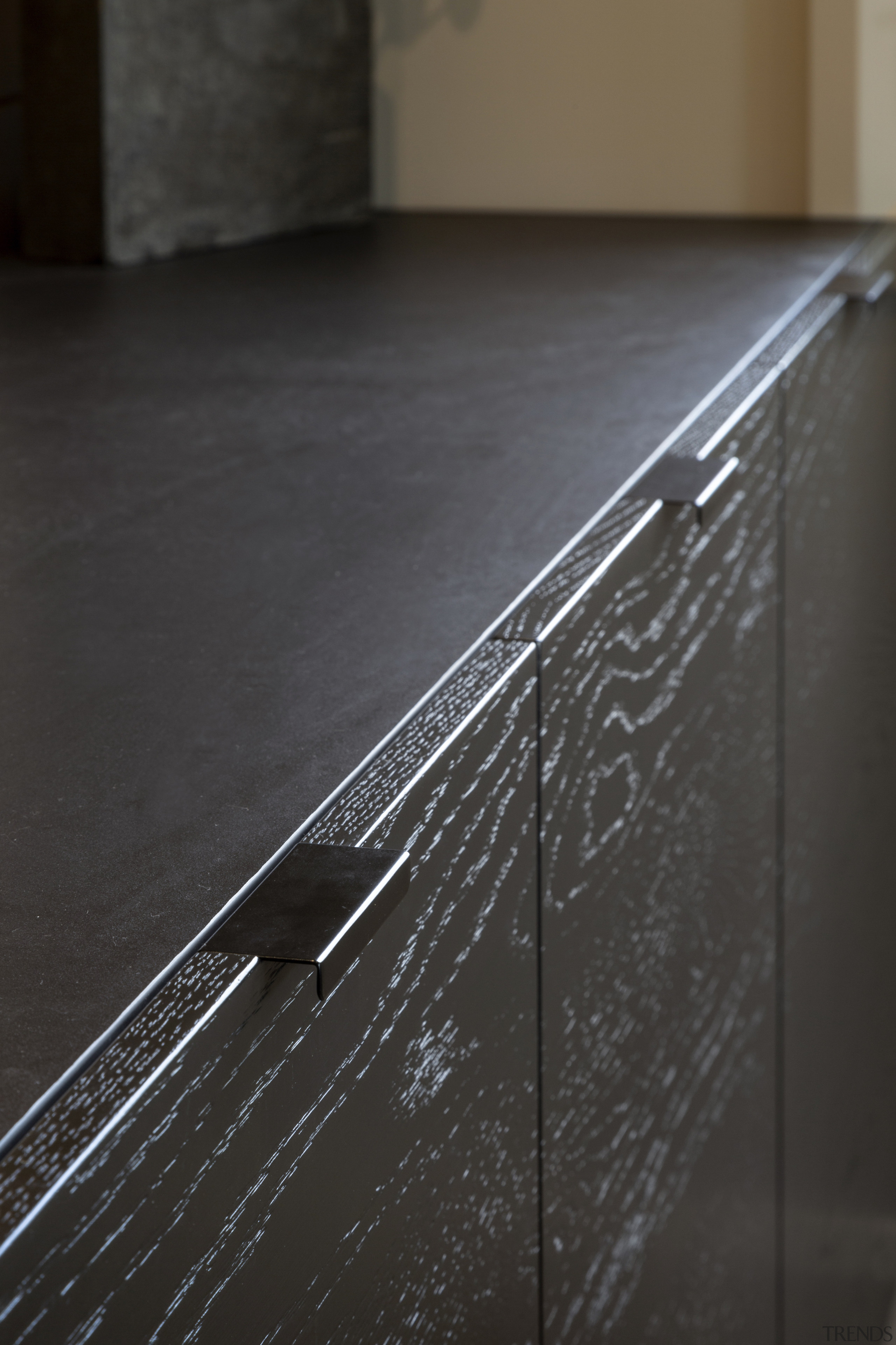 Minimalist pulls contribute to the kitchen's strong, minimalist 