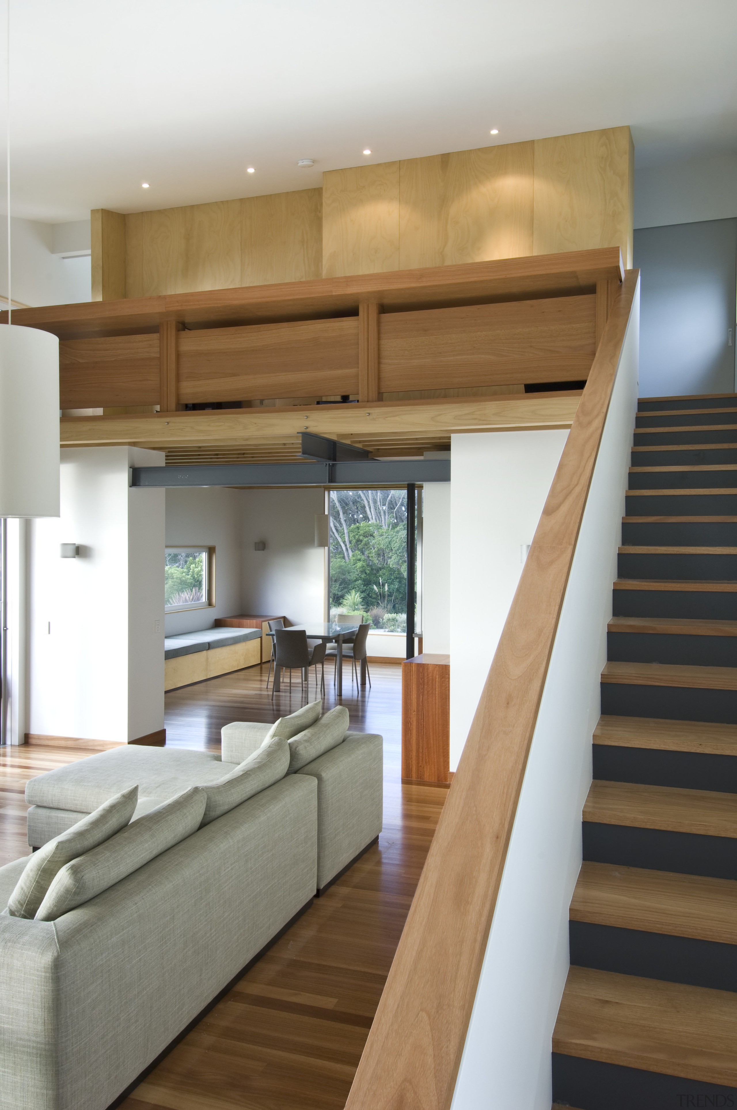 View of living area and stairway with a architecture, hardwood, house, interior design, living room, stairs, wood, white