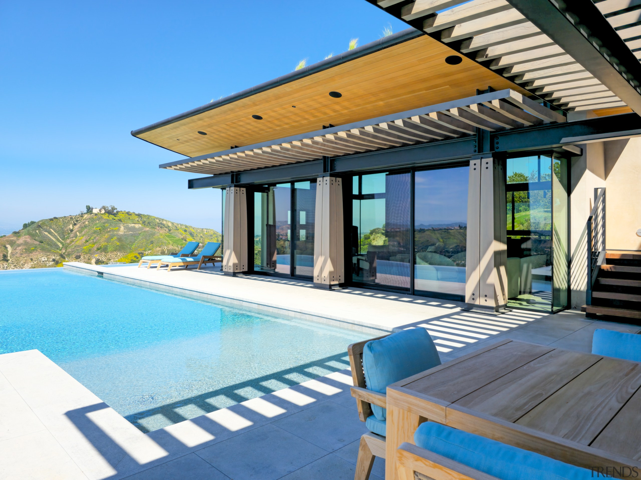 Pool and view room with deep roof overhangs. 