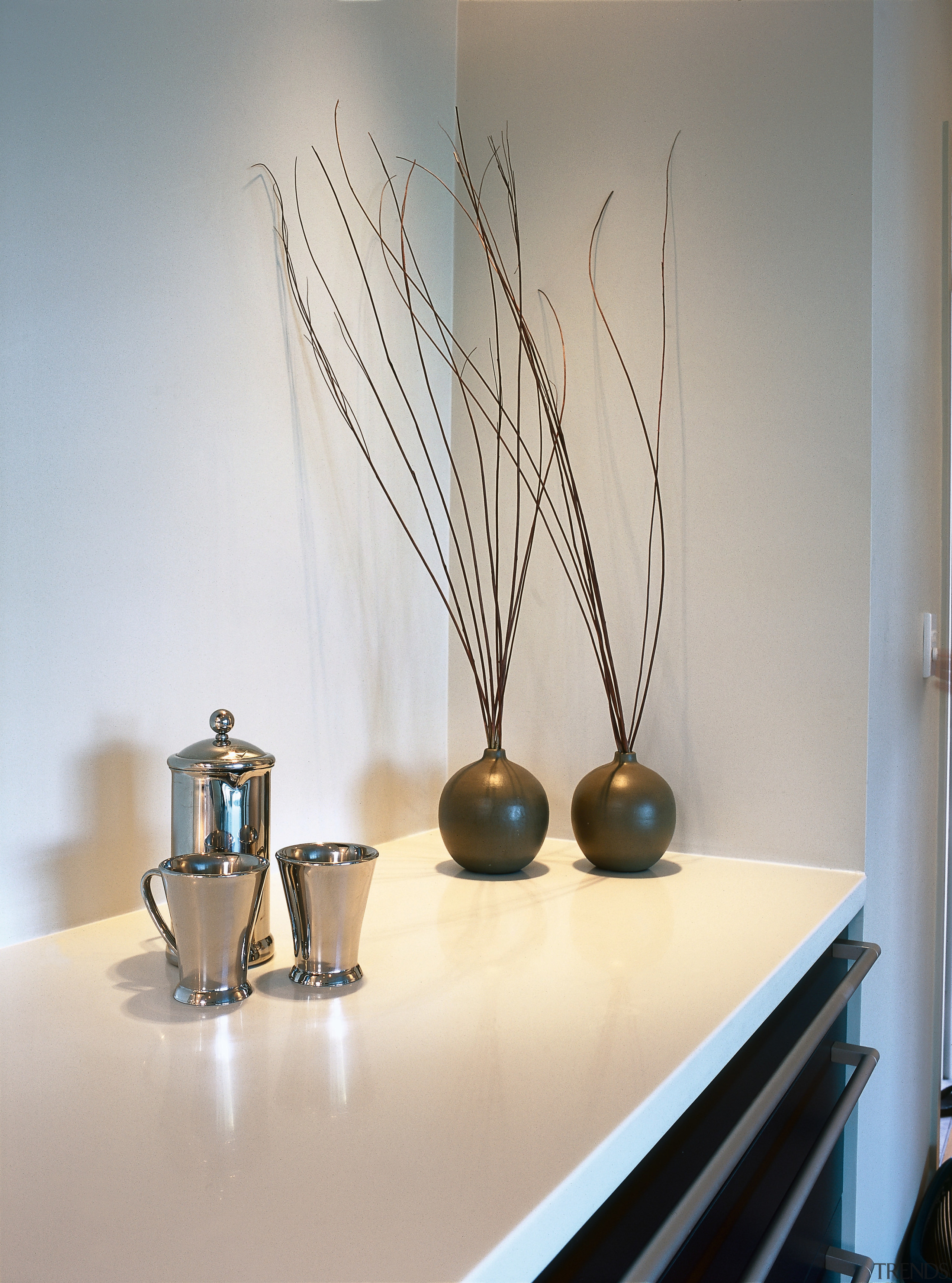 Kitchen with white countertop, dark gray cabinetry and interior design, lamp, light fixture, product design, still life photography, table, gray