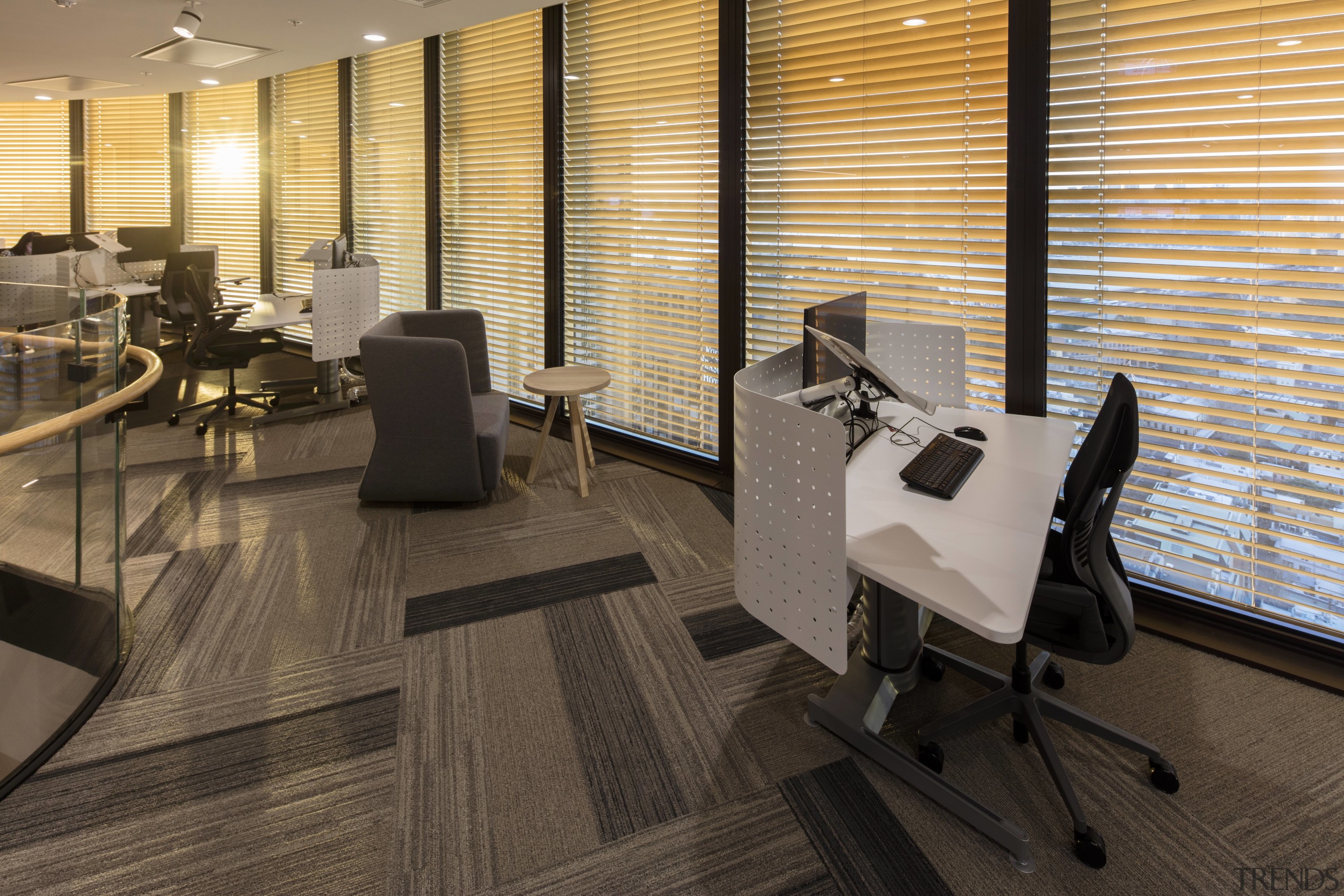 The automated blinds at the EY Centre are floor, flooring, furniture, hardwood, interior design, laminate flooring, lobby, office, wood, wood flooring, black, brown