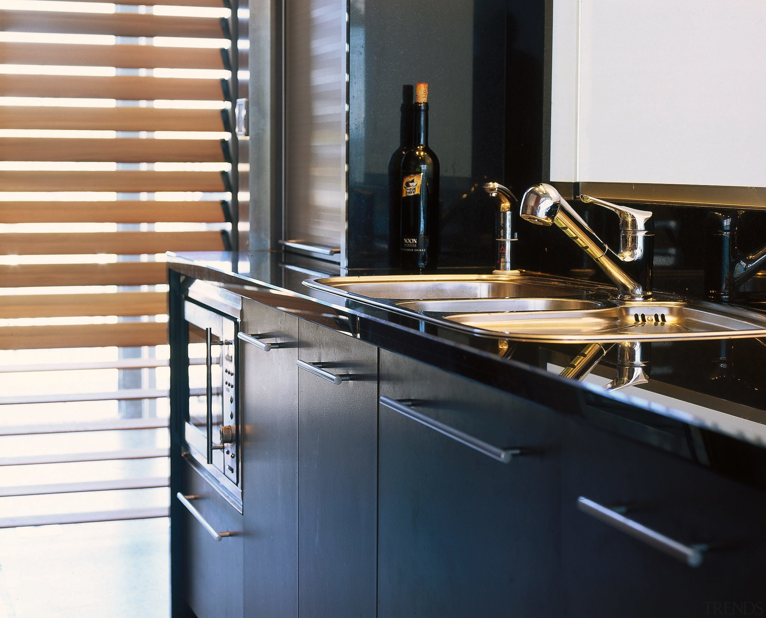 The detail of a sink, taps and cabinetry cabinetry, countertop, kitchen, black, white