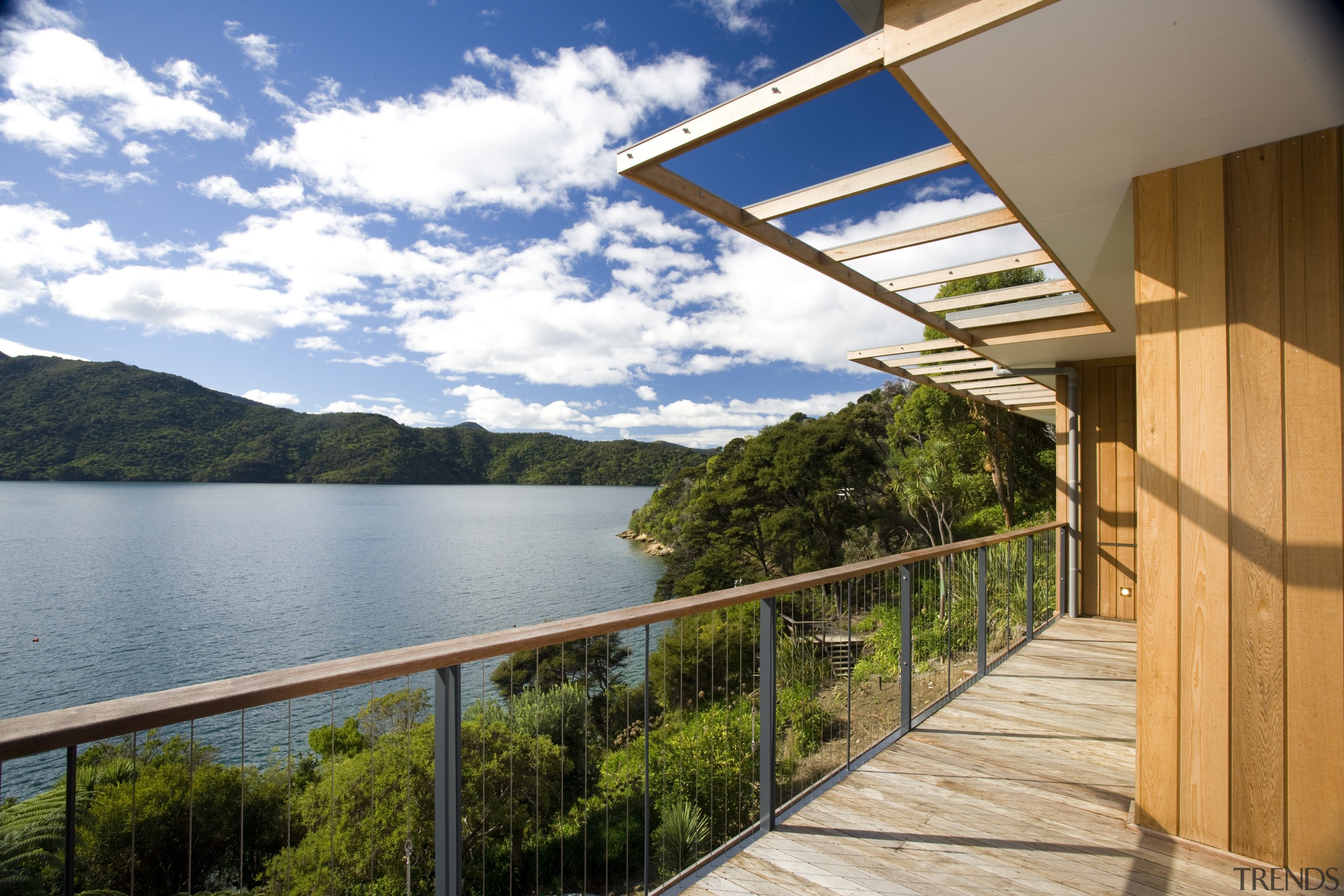 View of deck and side of house with architecture, balcony, cottage, estate, home, house, property, real estate, sky, villa, brown