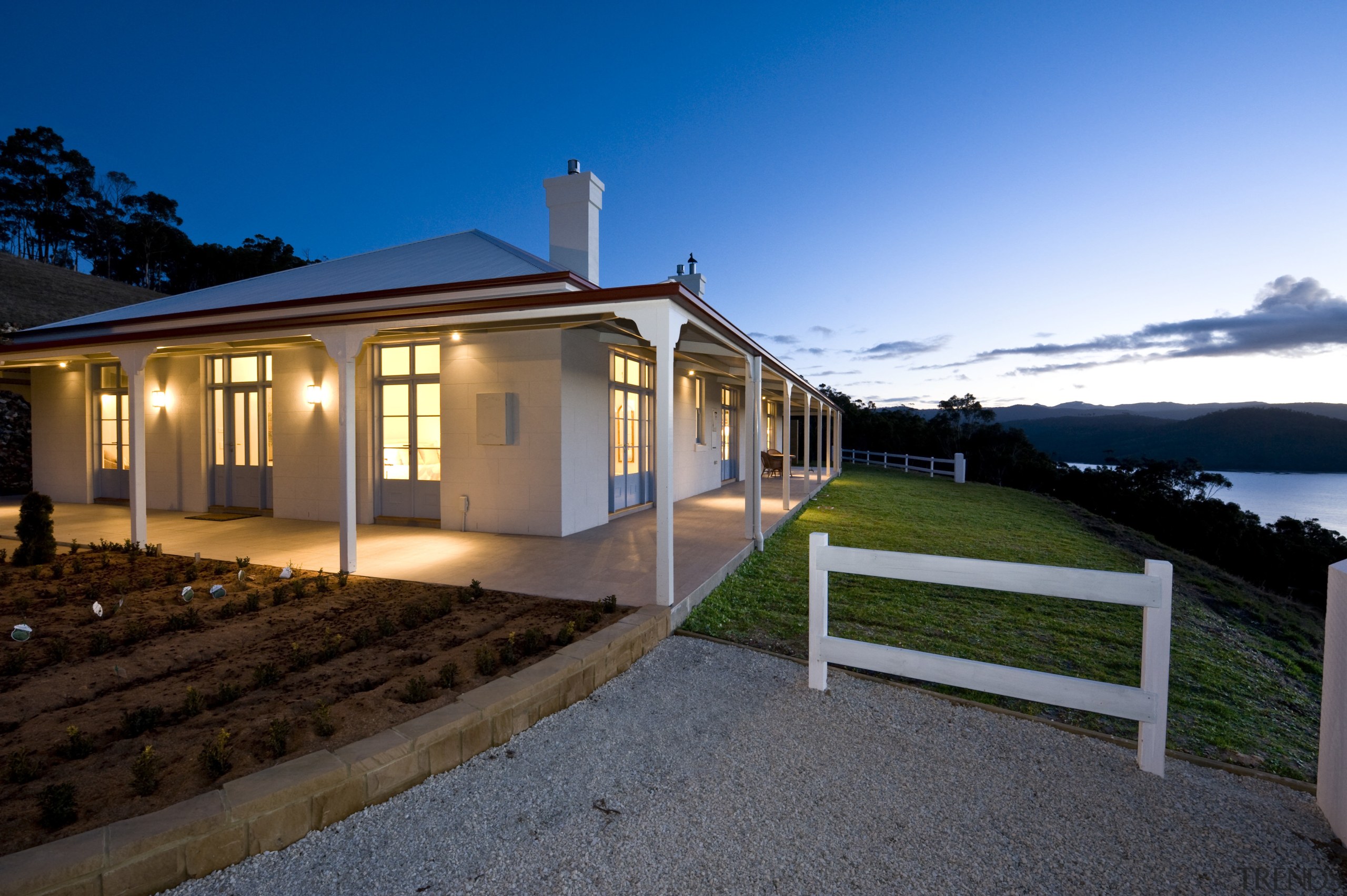 Exterior view of Victorian-syle house featuring steel roofing, cloud, cottage, estate, evening, facade, farmhouse, home, house, lighting, property, real estate, residential area, sky, villa