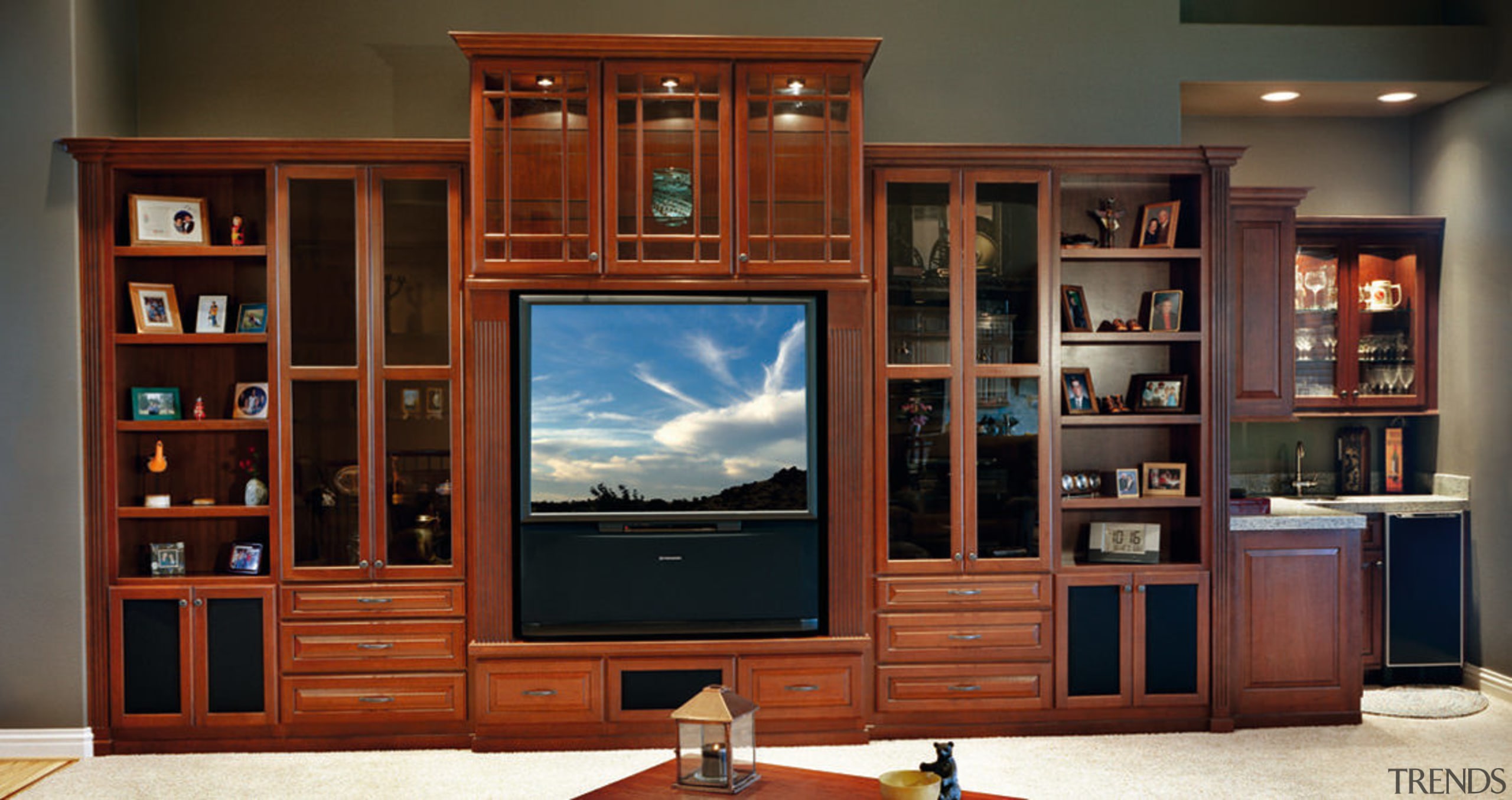 View of the cabinetry that hides the home bookcase, cabinetry, display case, entertainment center, furniture, living room, shelving, red