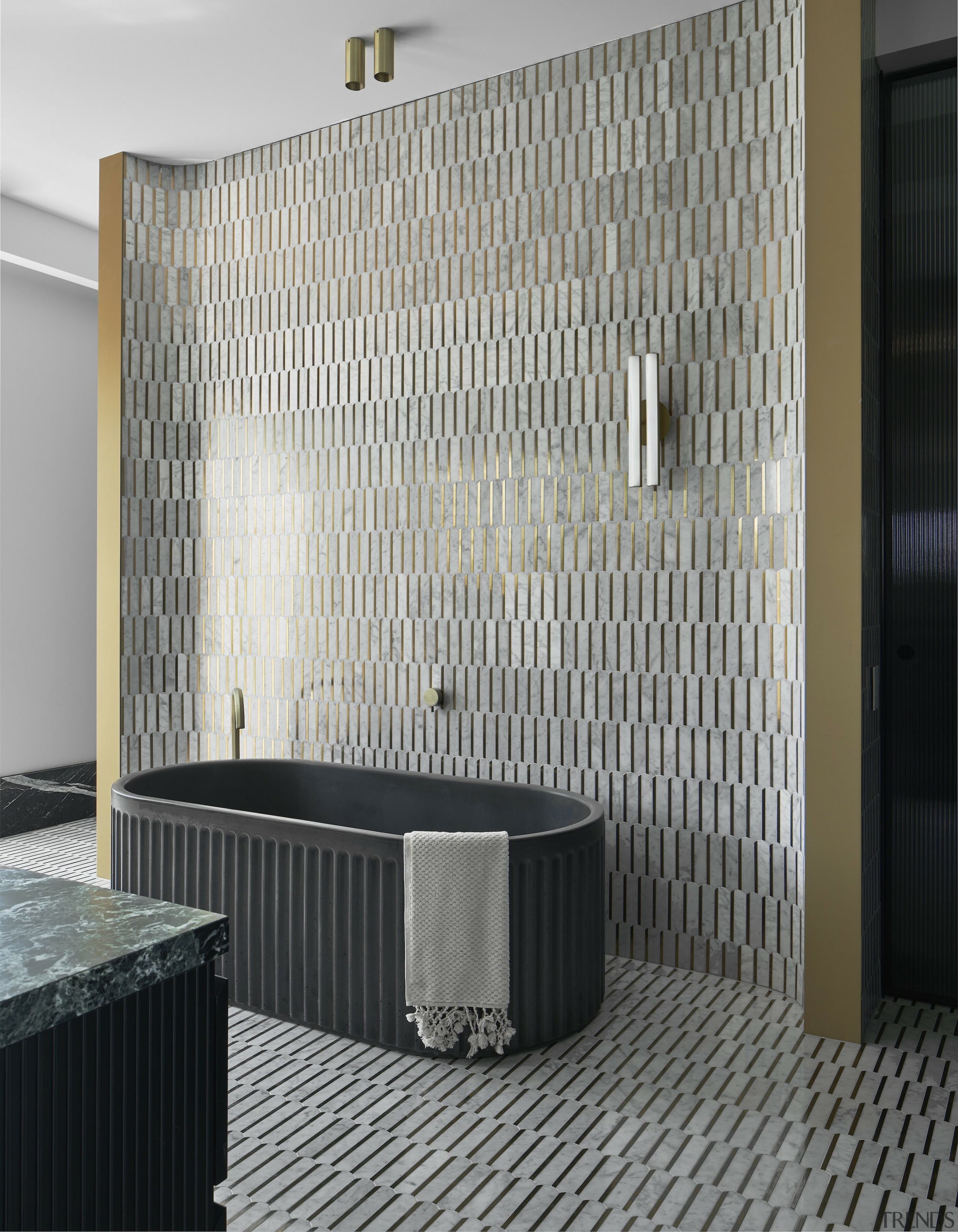 The brass-white Carrara marble feature wall is carried 